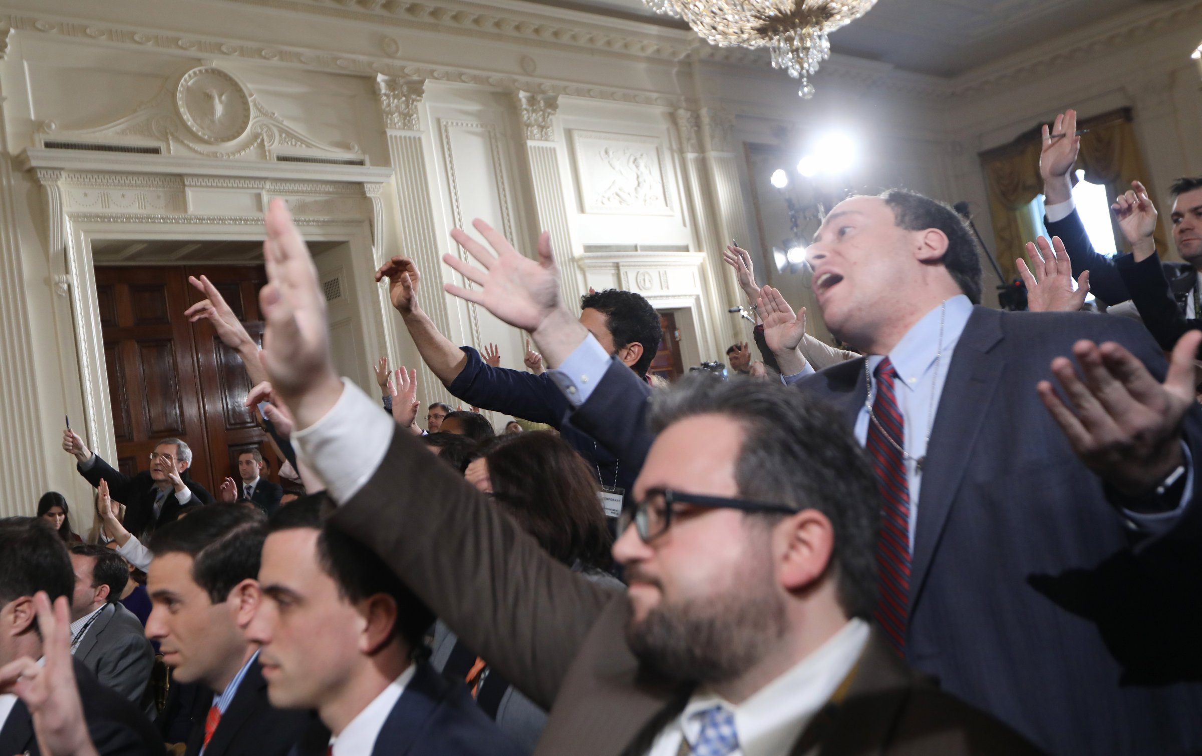 Reporters attempt to pose questions to President Donald Trump during a news conference announcing Alexander Acosta as the new Labor Secretary nominee in the East Room at the White House in Washington, on Feb. 16, 2017.