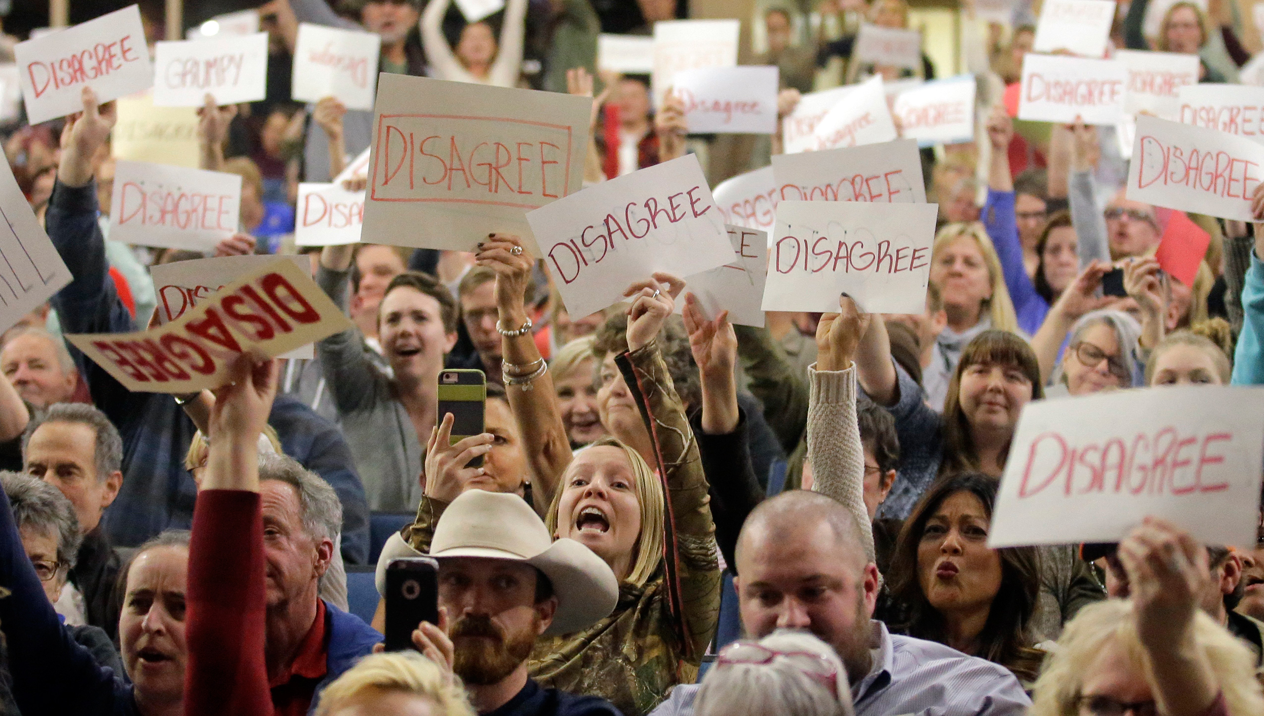 In this Thursday, Feb. 9, 2017 photo, people react as U.S. Rep. Jason Chaffetz speaks during a town hall meeting at Brighton High School in Cottonwood Heights, Utah. Some attendees of the contentious town hall hosted by Chaffetz have sent the congressman fake invoices after he claimed some people there were paid protesters. (Rick Bowmer—AP)