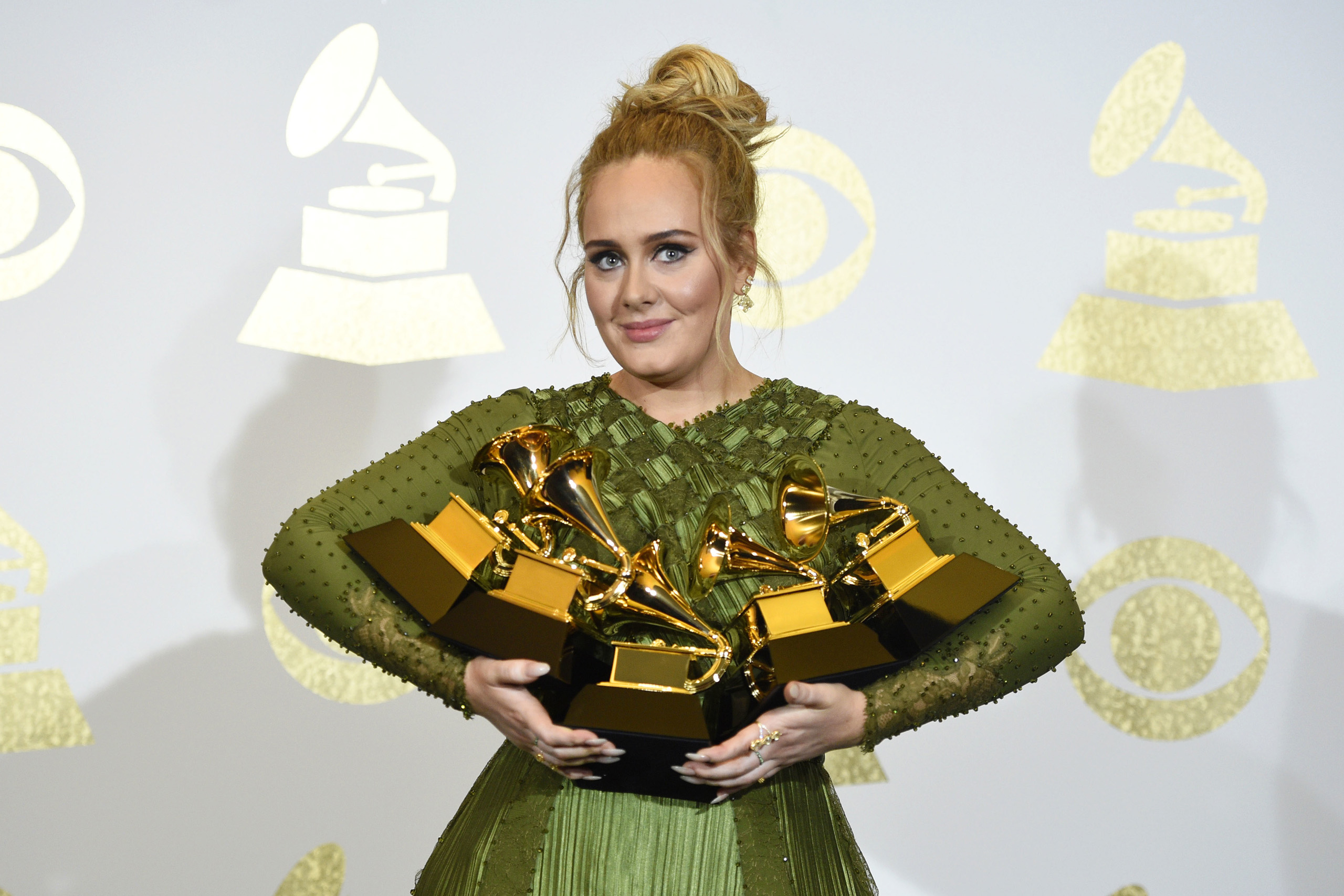 Adele poses with her five awards at the 59th annual Grammy Awards at the Staples Center on Feb. 12, 2017. (Chris Pizzello—Invision/AP)