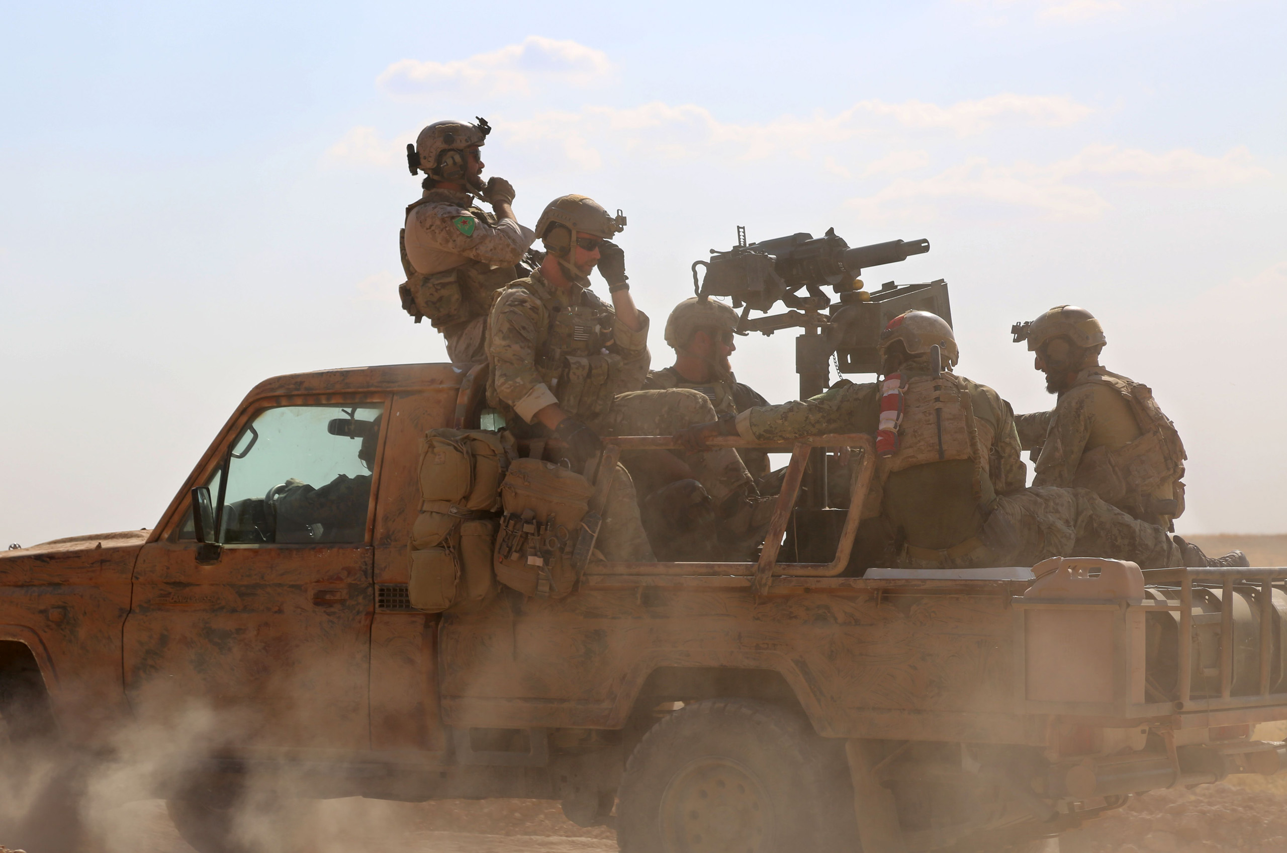 US special operations forces ride in the back of a pickup truck in the village of Fatisah in the northern Syrian province of Raqa on May 25, 2016. (Delil Souleiman—AFP/Getty Images)