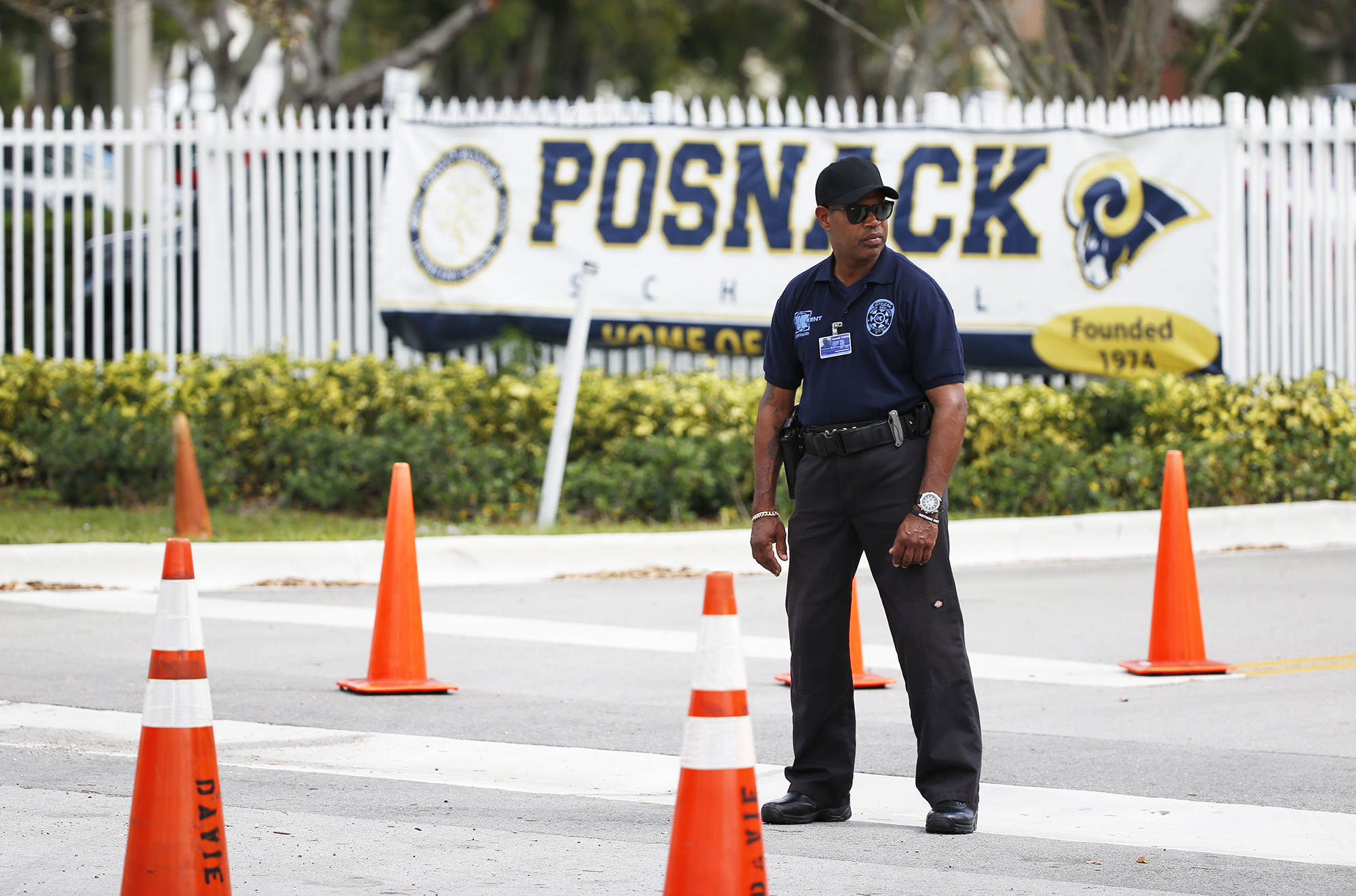 A security guard stands outside the entrance to the David Posnack Jewish Community Center and David Posnack Jewish Day School after people were evacuated because of a bomb threat, on Feb. 27, 2017, in Davie, Fla. (Wilfredo Lee—AP)