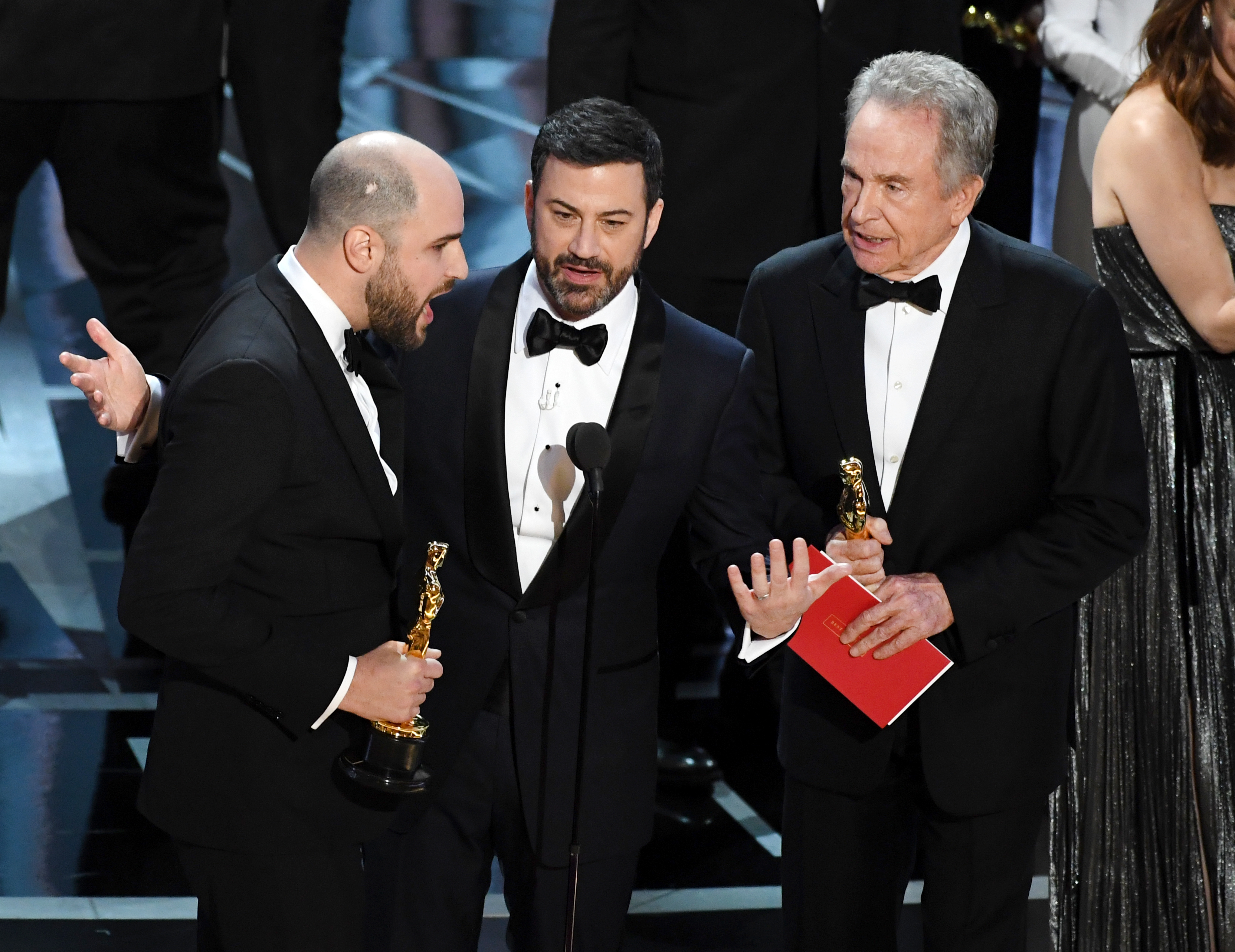 'La La Land' producer Jordan Horowitz (L) announces actual Best Picture winner as 'Moonlight' after a presentation error with host Jimmy Kimmel and actor Warren Beatty onstage during the 89th Annual Academy Awards on February 26, 2017 in Hollywood, California.