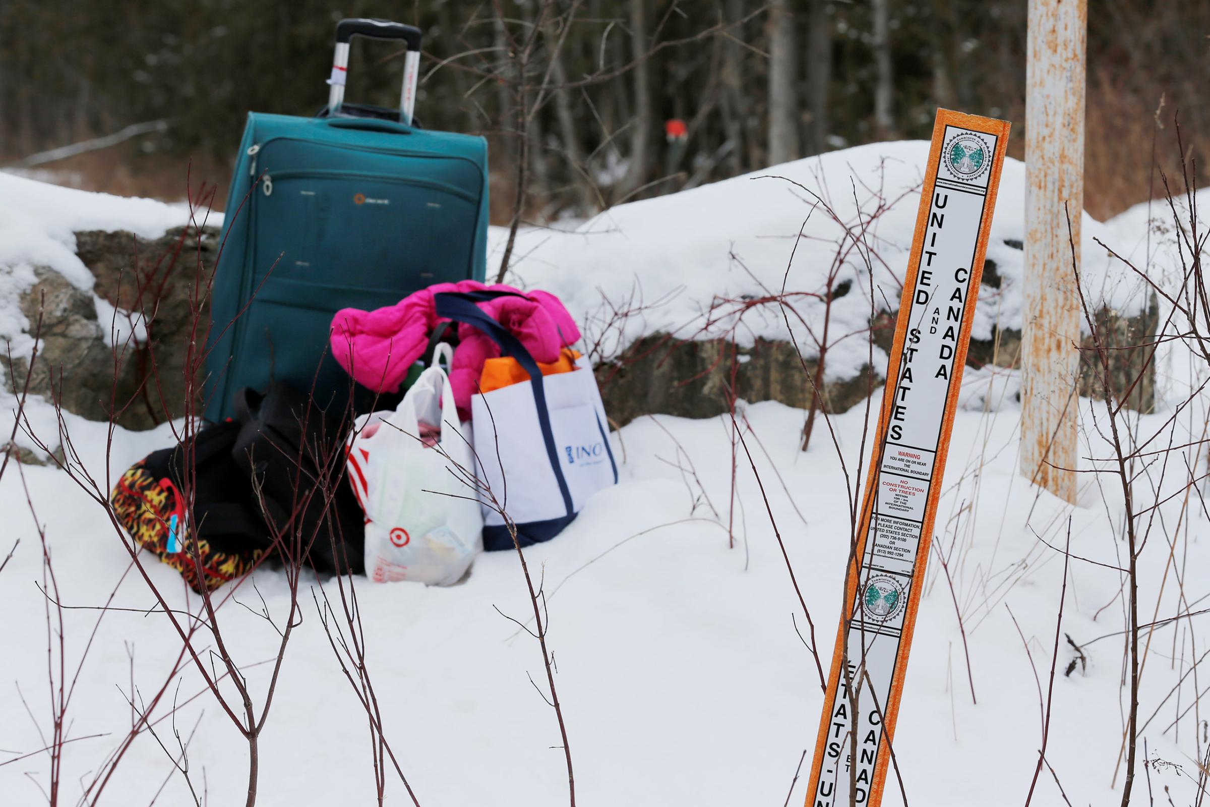 Luggage sits on the U.S. side of the border after a woman who told police that she and her family were from Sudan is taken into custody by Royal Canadian Mounted Police officers after walking across the U.S.-Canada border into Hemmingford