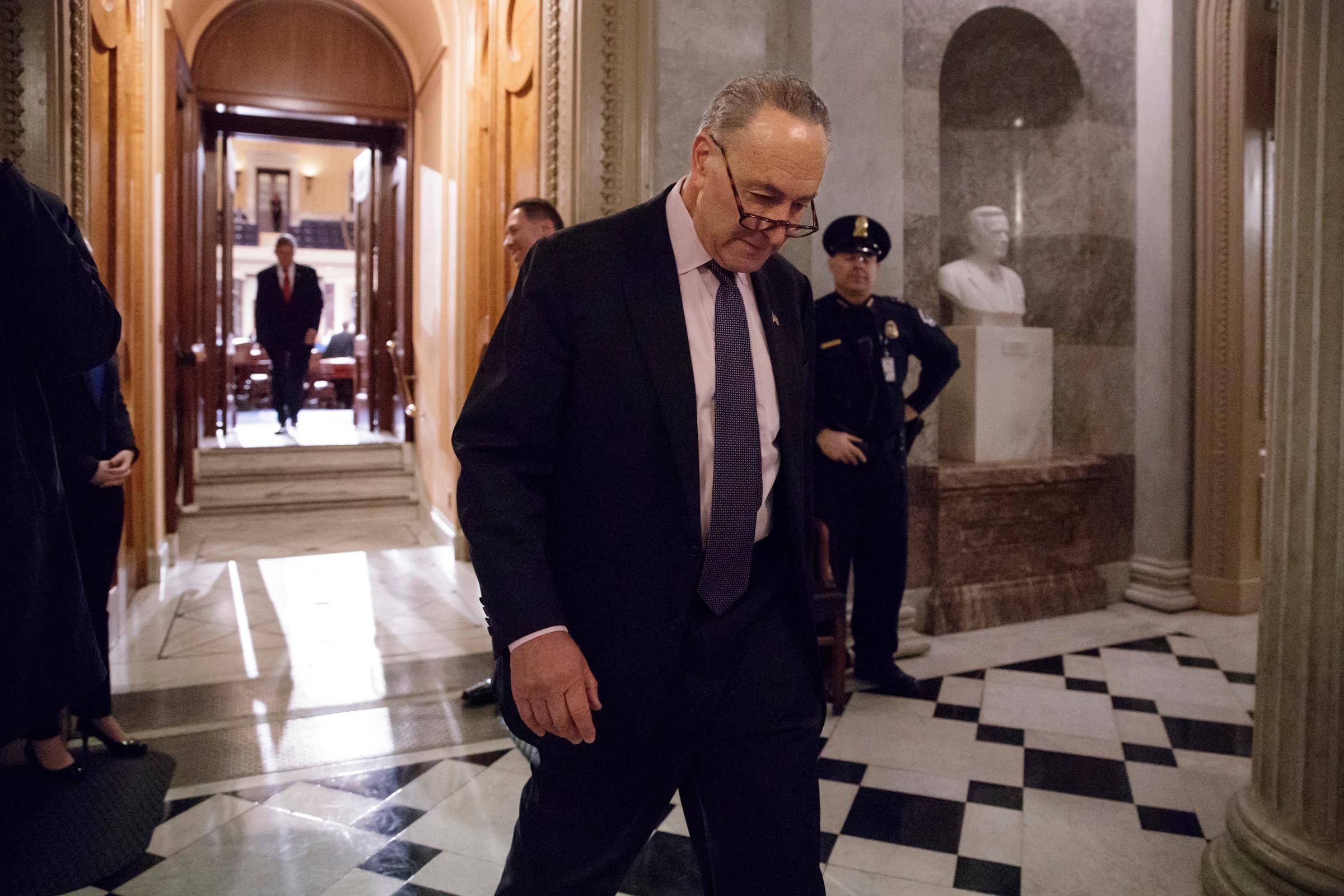 Senate Minority Leader Charles Schumer of N.Y. departs the Senate chamber, as lawmakers gathered for a predawn vote to advance the nomination of Education Secretary-designate Betsy DeVos, Washington, D.C., Feb. 3, 2017.