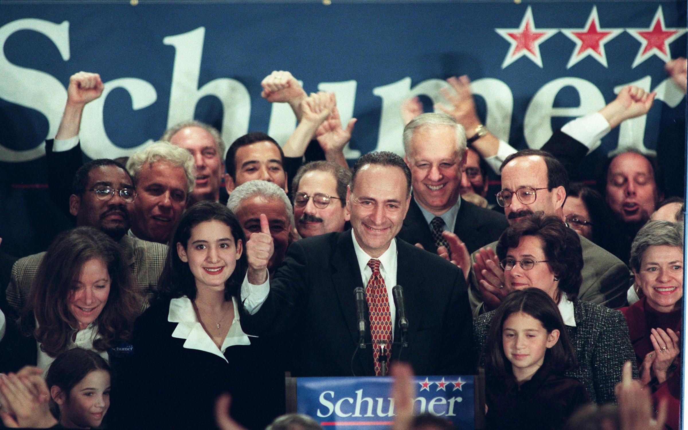 Senator-elect Charles Schumer (C) is surrounded by his wife Iris (2nd from R) and daughters Jessica (L) and Alison (R) after he defeated incumbent Republican Senator Alphonse D'Amato in the New York senatorial race in New York, Nov.3, 1998.