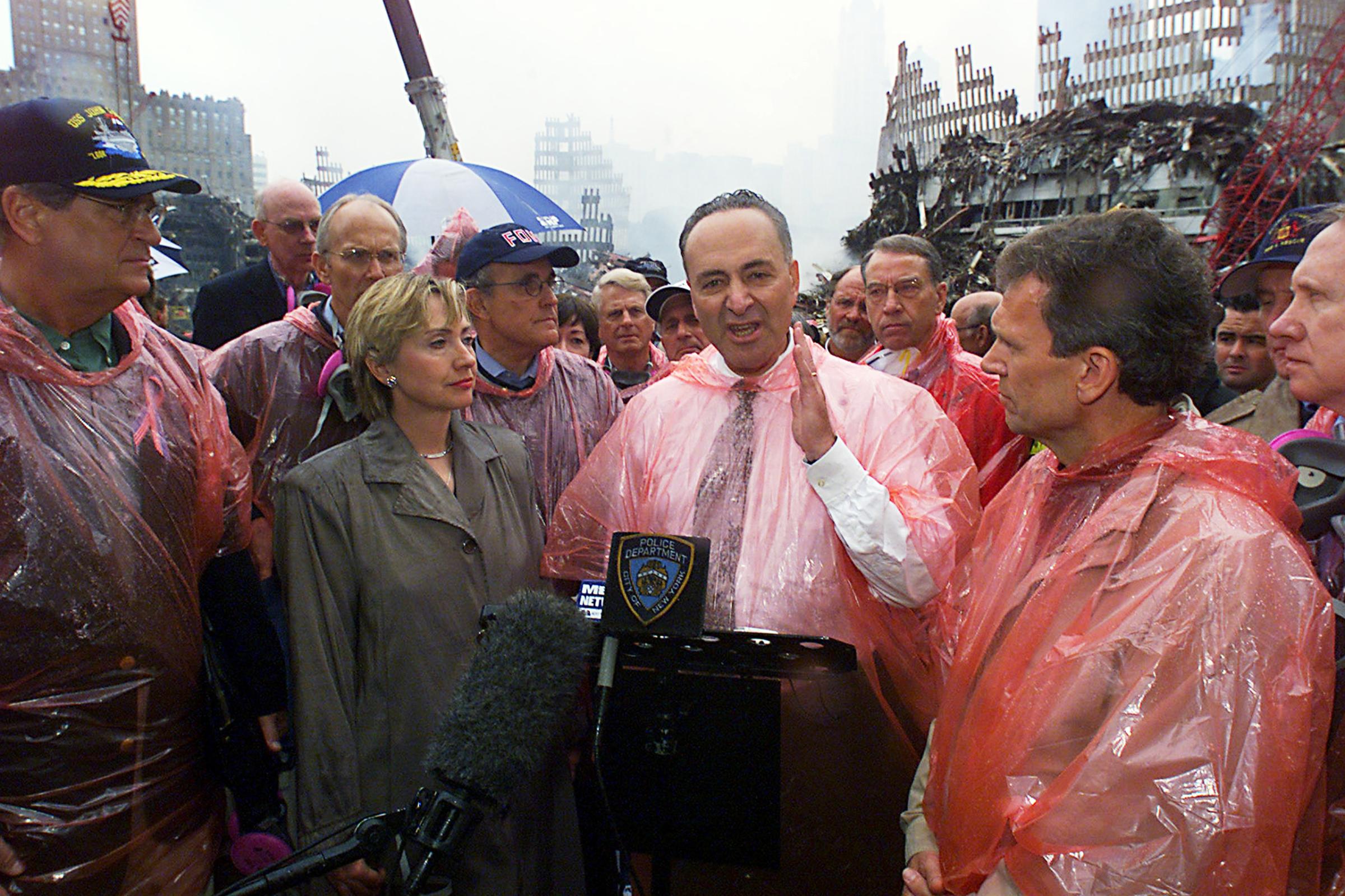 Sen. Schumer speaks as Sen. Hillary Rodham Clinton, Mayor Giuliani and members of a congressional delegation look on during a visit to the scene of devastation where the World Trade Center's twin towers stood, New York, Sept. 20, 2001.