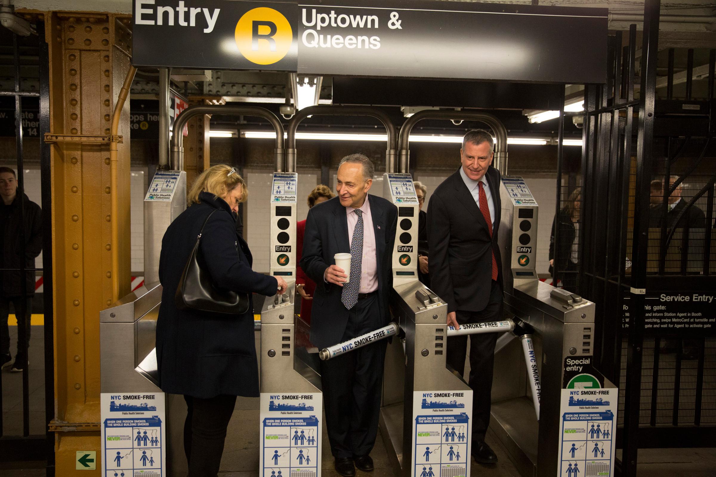 New York City Mayor Bill de Blasio, right, and Sen. Schumer. exit the subway system after riding the train to City Hall in New York, April 9, 2015. De Blasio and Schumer took the trip as part of National Stand Up for Transportation Day, designed to call attention to the need for a long-term, sustainable and reliable federal transportation funding bill.