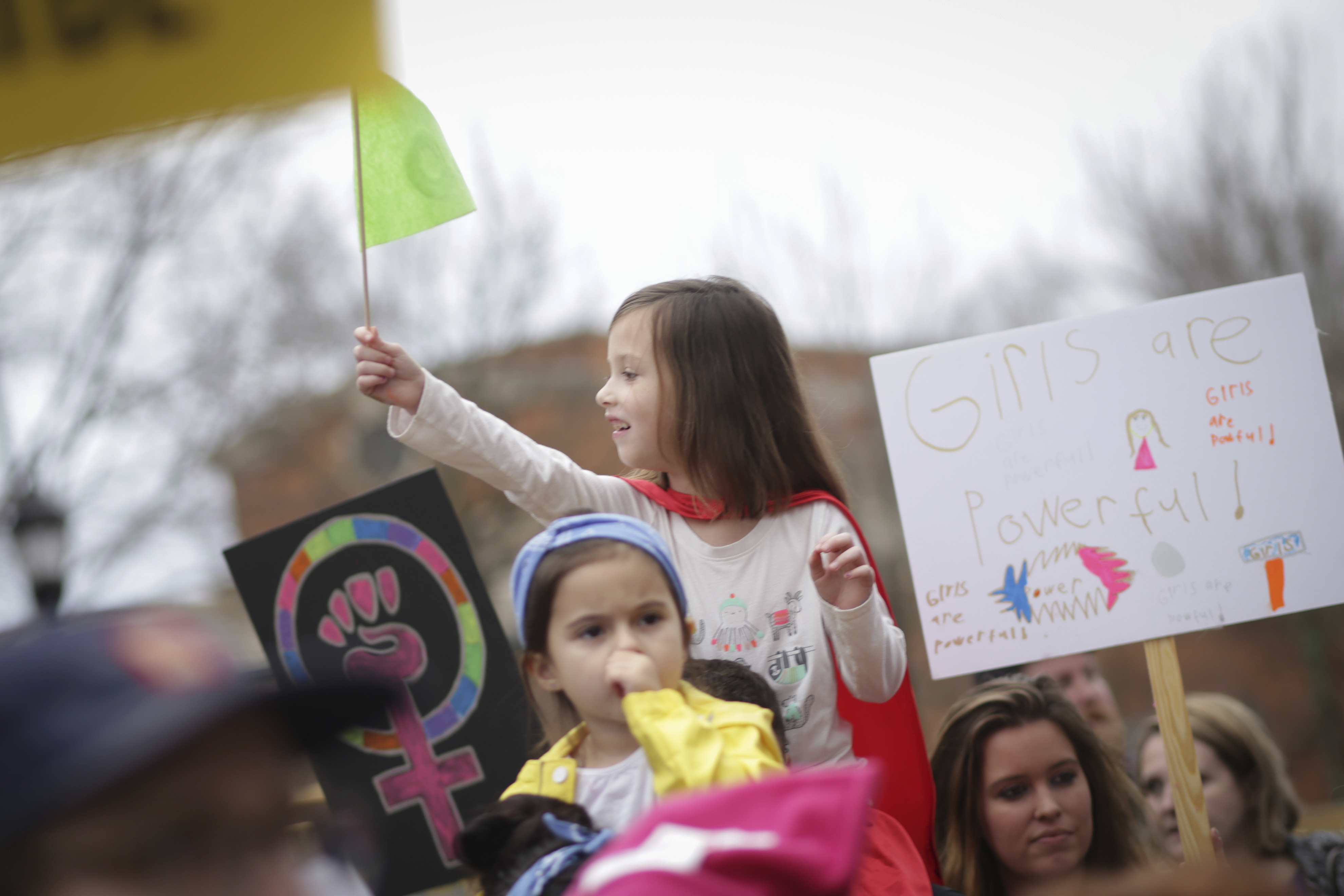 A young girl waves a flag during the Women's March in Athens, Ga., on Jan. 21, 2017 (John Roark—AP)