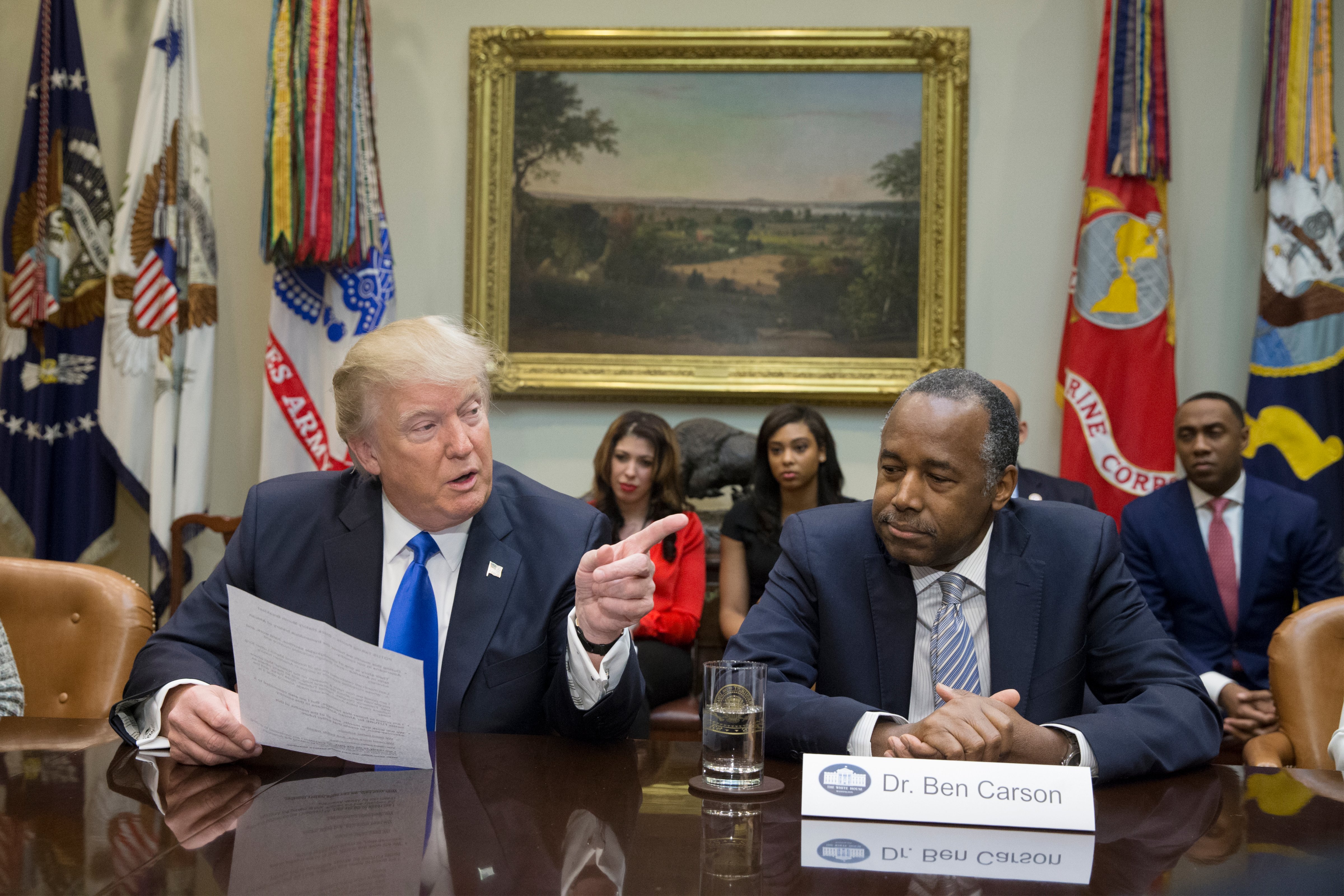 President Donald Trump (L), holds an African American History Month listening session attended by nominee to lead the Department of Housing and Urban Development Ben Carson (R) and other officials in the Roosevelt Room of the White House on Feb. 1, 2017 in Washington, D.C. (Michael Reynolds&mdash;Pool/Getty Images)
