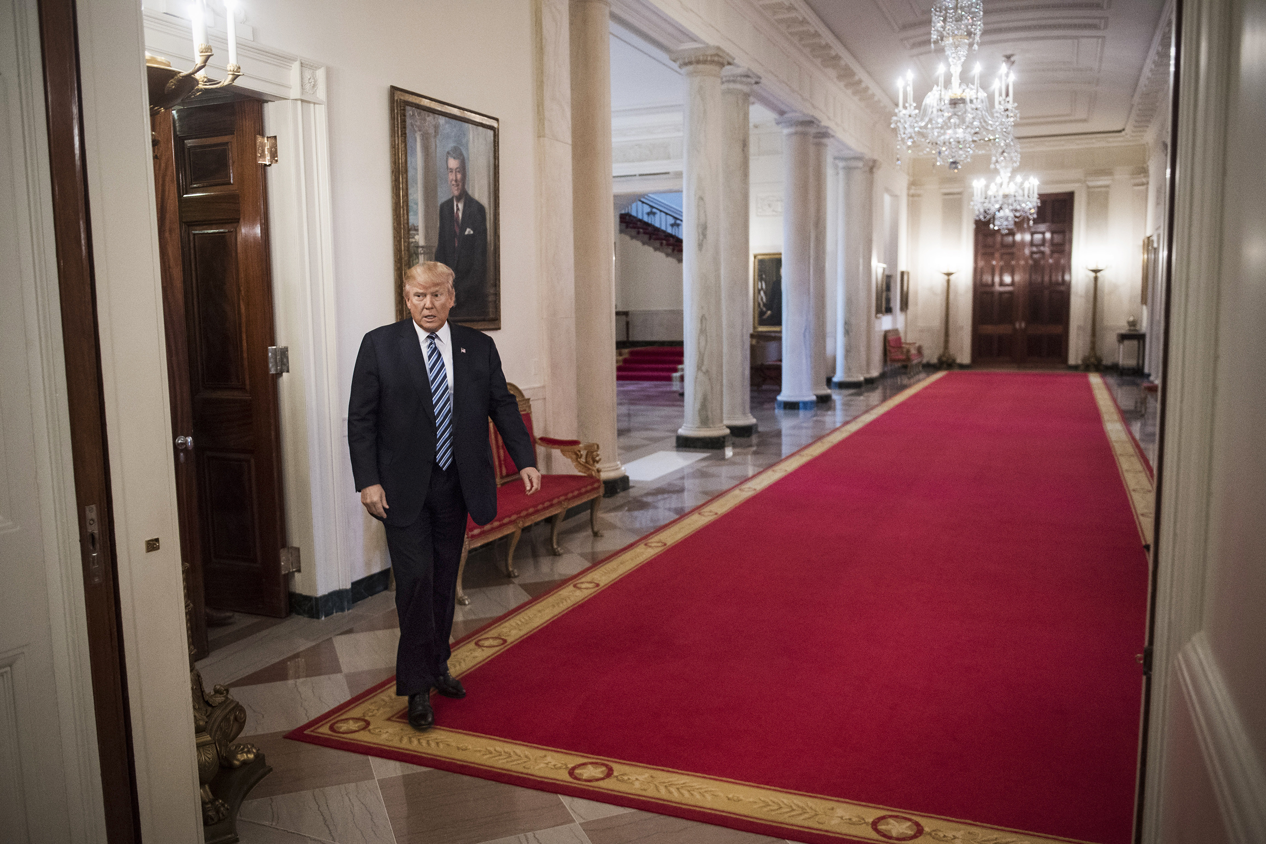 The President walks through the Cross Hall of the White House before a meeting with airline executives on Feb. 9 (Jabin Botsford—The Washington Post/Getty Images)