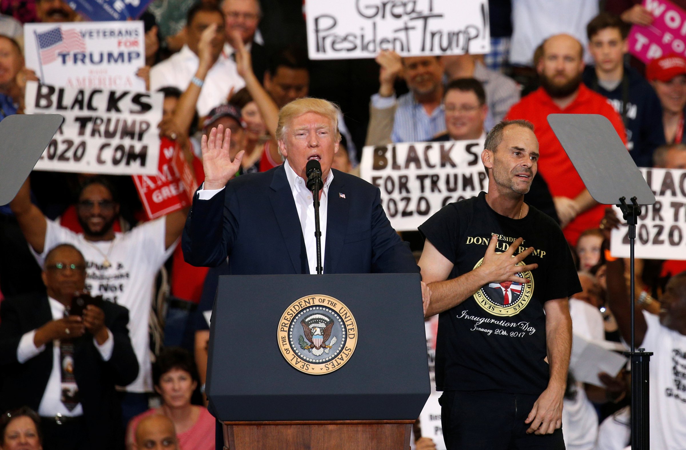 Trump holds a supporter invited onstage by U.S. President Donald Trump puts his hand to his chest during a "Make America Great Again" rally at Orlando Melbourne International Airport in Melbourne, Florida, U.S. February 18, 2017. REUTERS/Kevin Lamarque - RTSZBJF rally in Melbourne, Florida