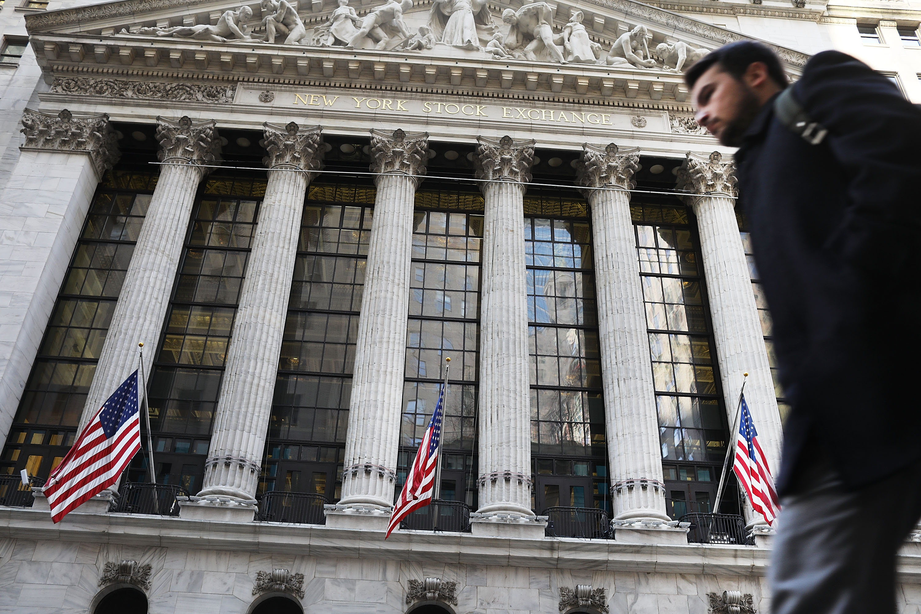 People walk by the New York Stock Exchange (NYSE) on Feb. 6, 2017 in New York City. (Spencer Platt&mdash;Getty Images)