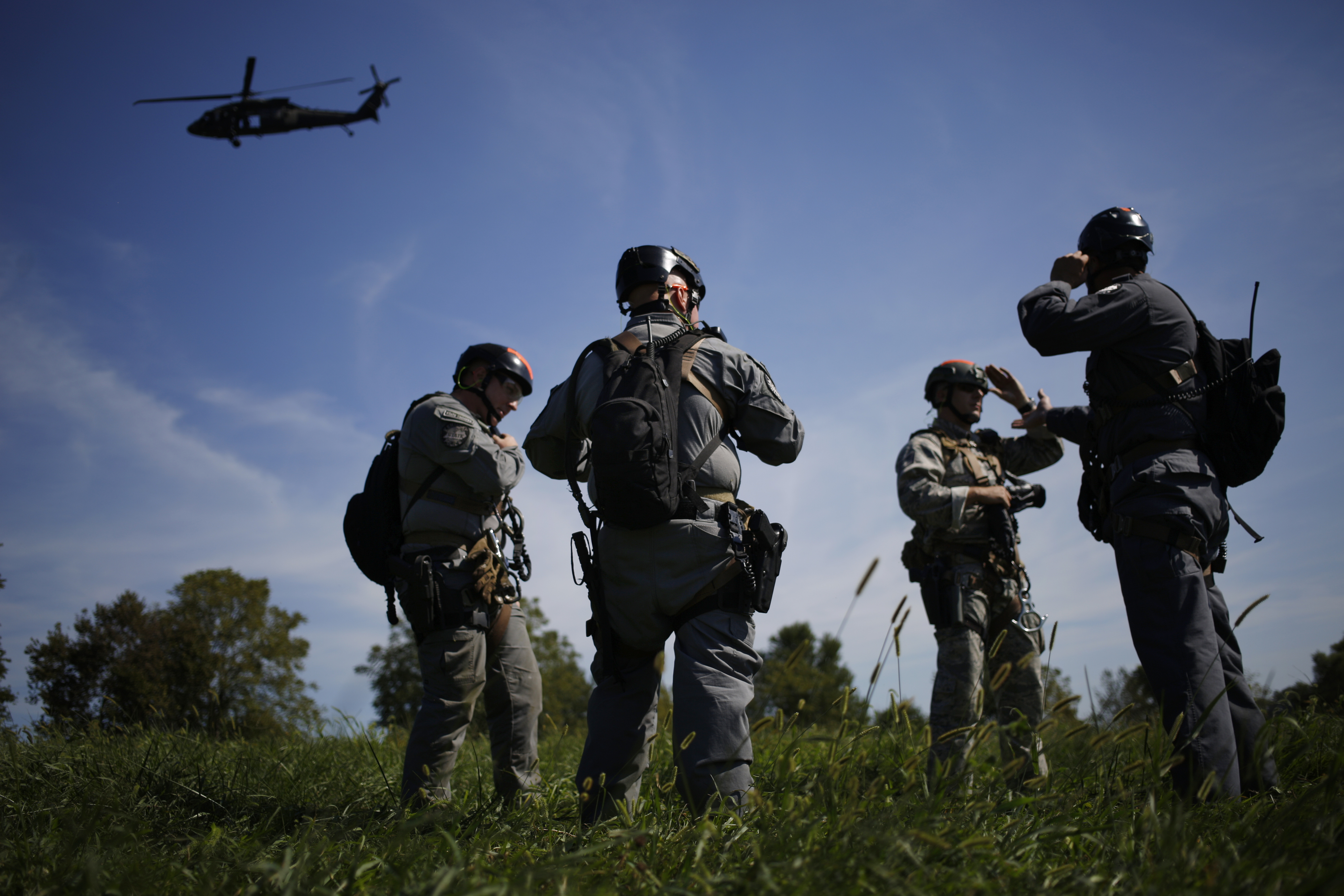 Members of the Kentucky State Police Cannabis Suppression Branch search for a patch of illegal marijuana after rappelling from a Kentucky National Guard UH-60 Blackhawk helicopter in Midway, Kentucky, U.S., on Wednesday, Sept. 14, 2016. (Luke Sharrett/Bloomberg via Getty Images)