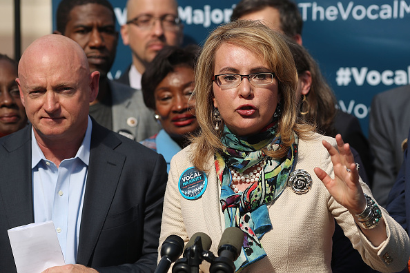 Gun violence victim and former U.S. Congresswoman Gabby Giffords speaks next to her husband, NASA astronaut Mark Kelly, as they visits City Hall on her 2016 Vocal Majority Tour on October 17, 2016 in New York City.