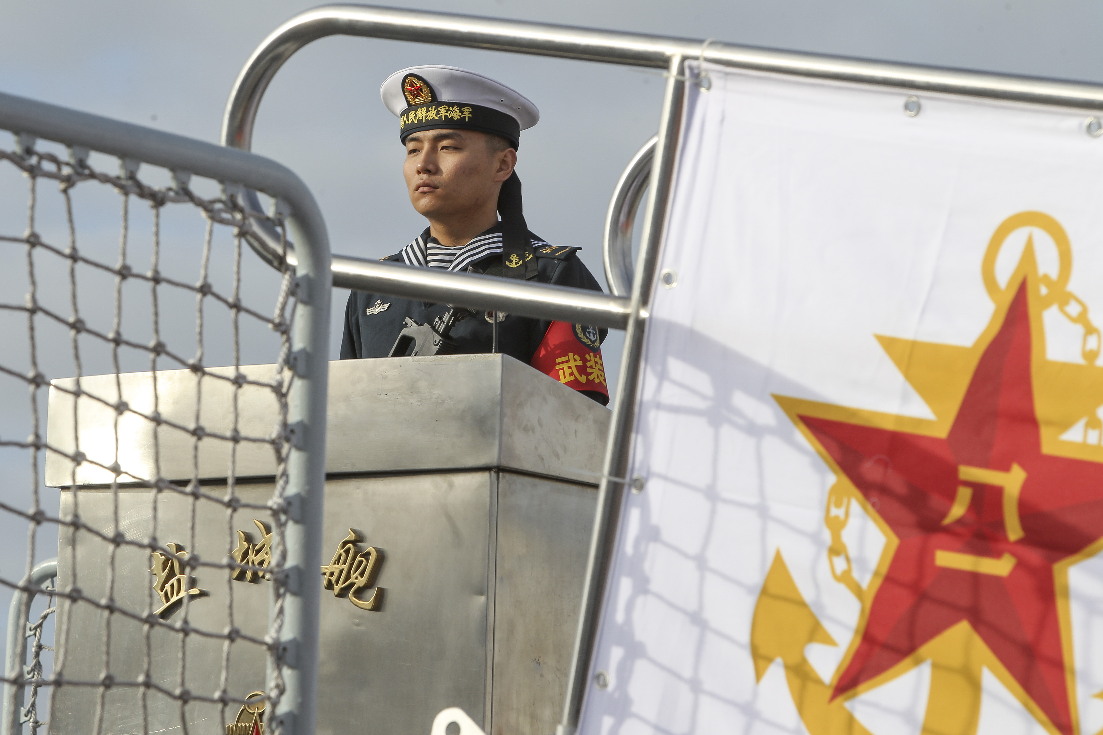 A Chinese sailor stands guard at the gang plank of a Chinese Naval frigate in San Diego on Dec. 6, 2016. (Bill Wetchter—AFP/Getty Images)