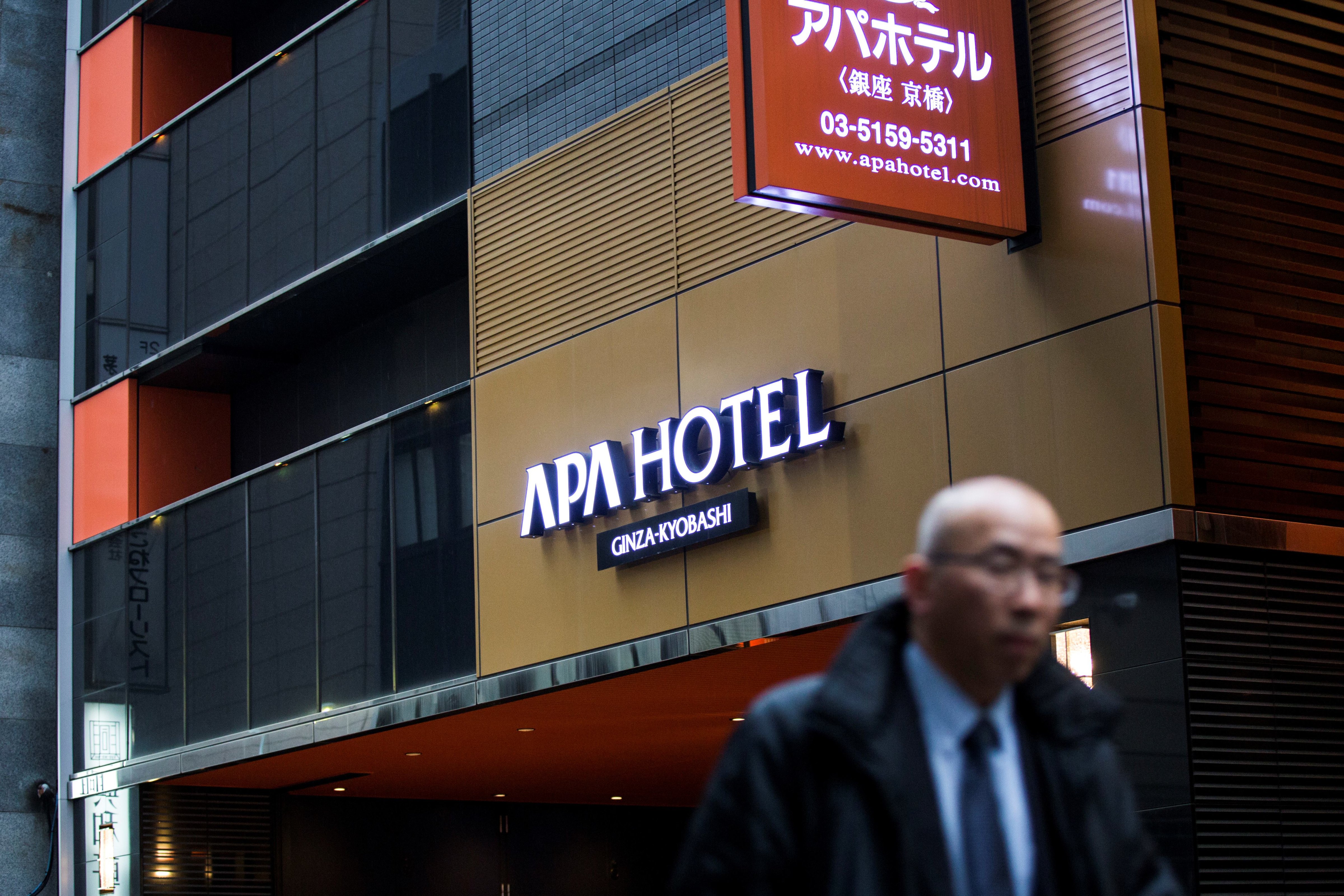 A man walks past the entrance of an APA hotel in central Tokyo on Jan. 20, 2017 (Behrouz Mehri—AFP/Getty Images)