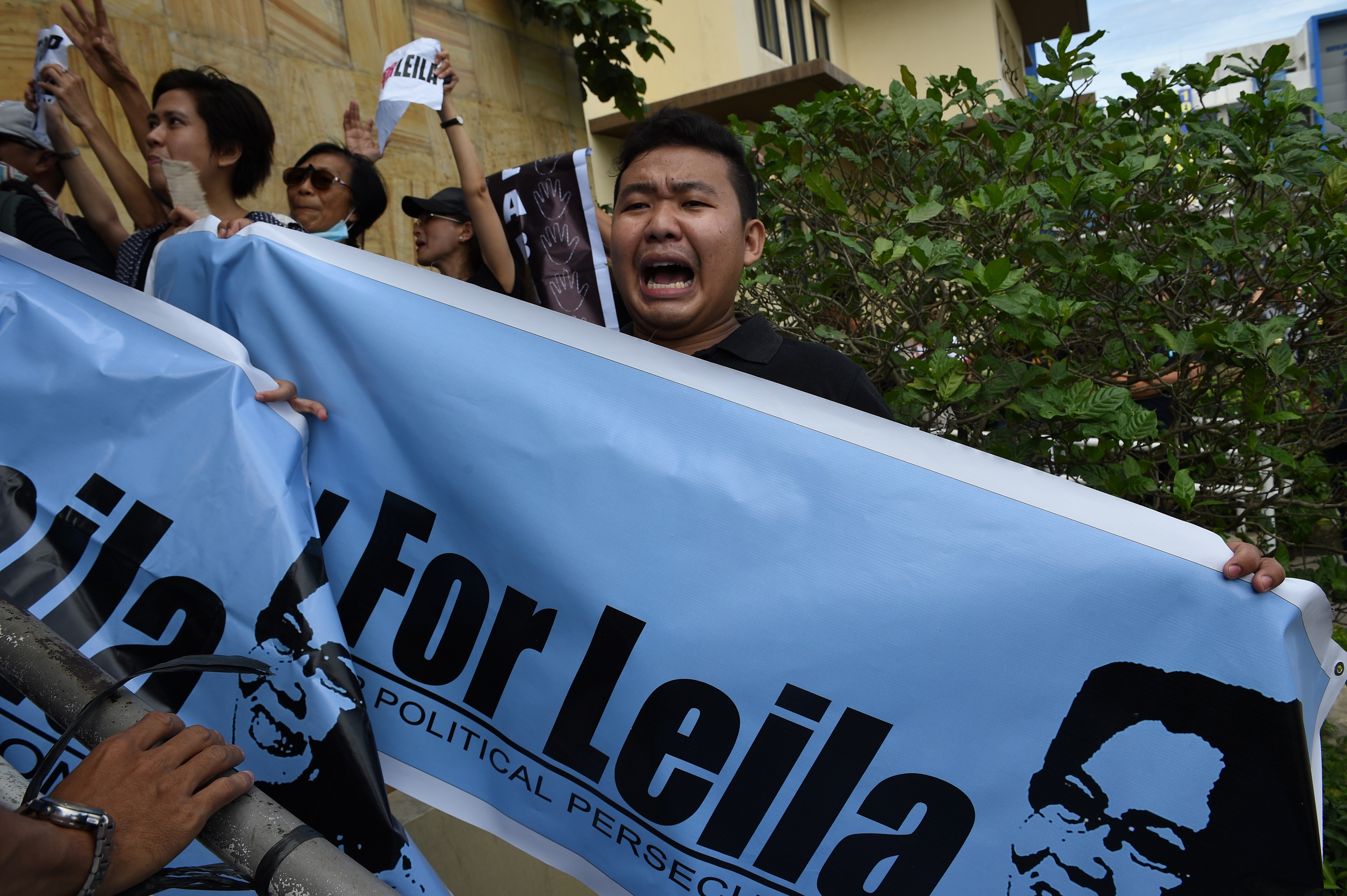 A supporter of Senator Leila De Lima shouts slogans as they hold a rally outside the court building in Muntinlupa City, suburban Manila on Feb. 24, 2017. (TED ALJIBE—AFP/Getty Images)