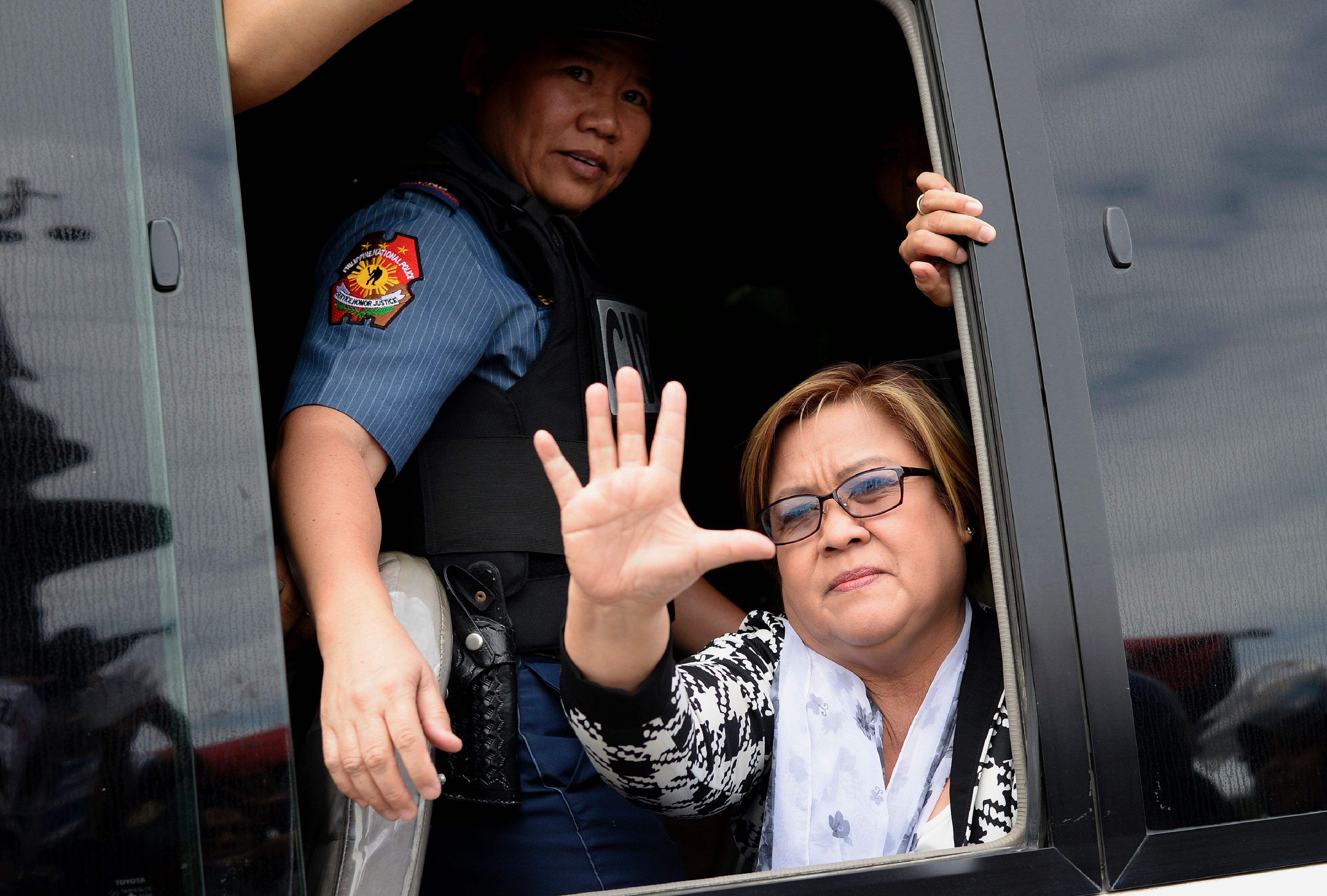 Philippine Senator Leila De Lima waves to her supporters after appearing at a court in Muntinlupa City, suburban Manila on Feb. 24, 2017. (Noel Celis—AFP/Getty Images)