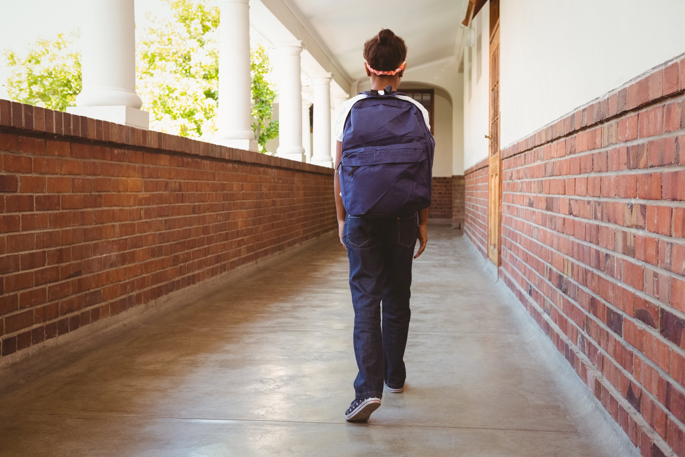 Girl walking in school corridor