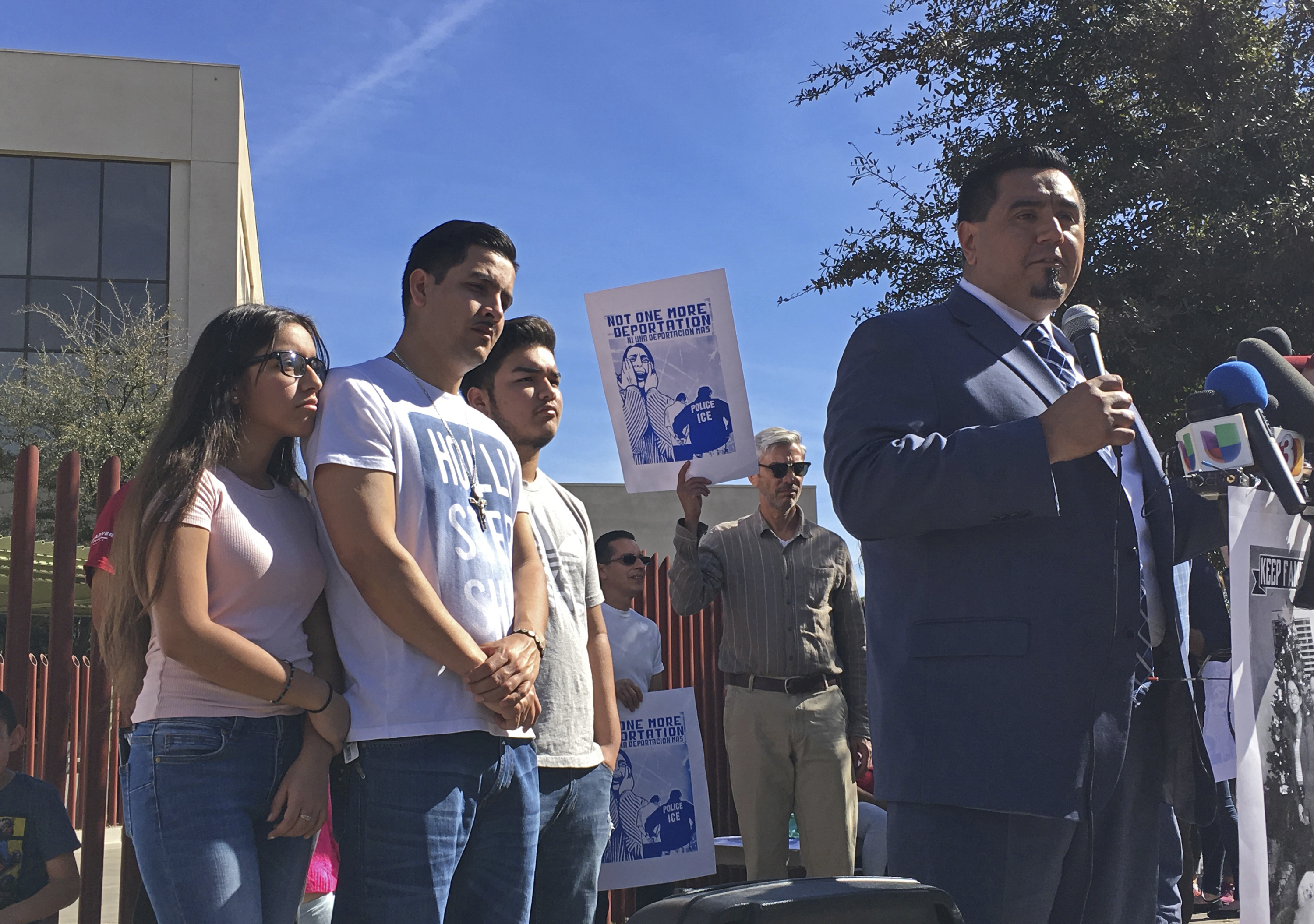 The family of Guadalupe Garcia de Rayos stands behind her attorney, Ray Ybarra Maldonado, as he speaks in front of the U.S. Immigration and Customs Enforcement office in Phoenix on Feb. 9, 2017. (Astrid Galvan—AP)