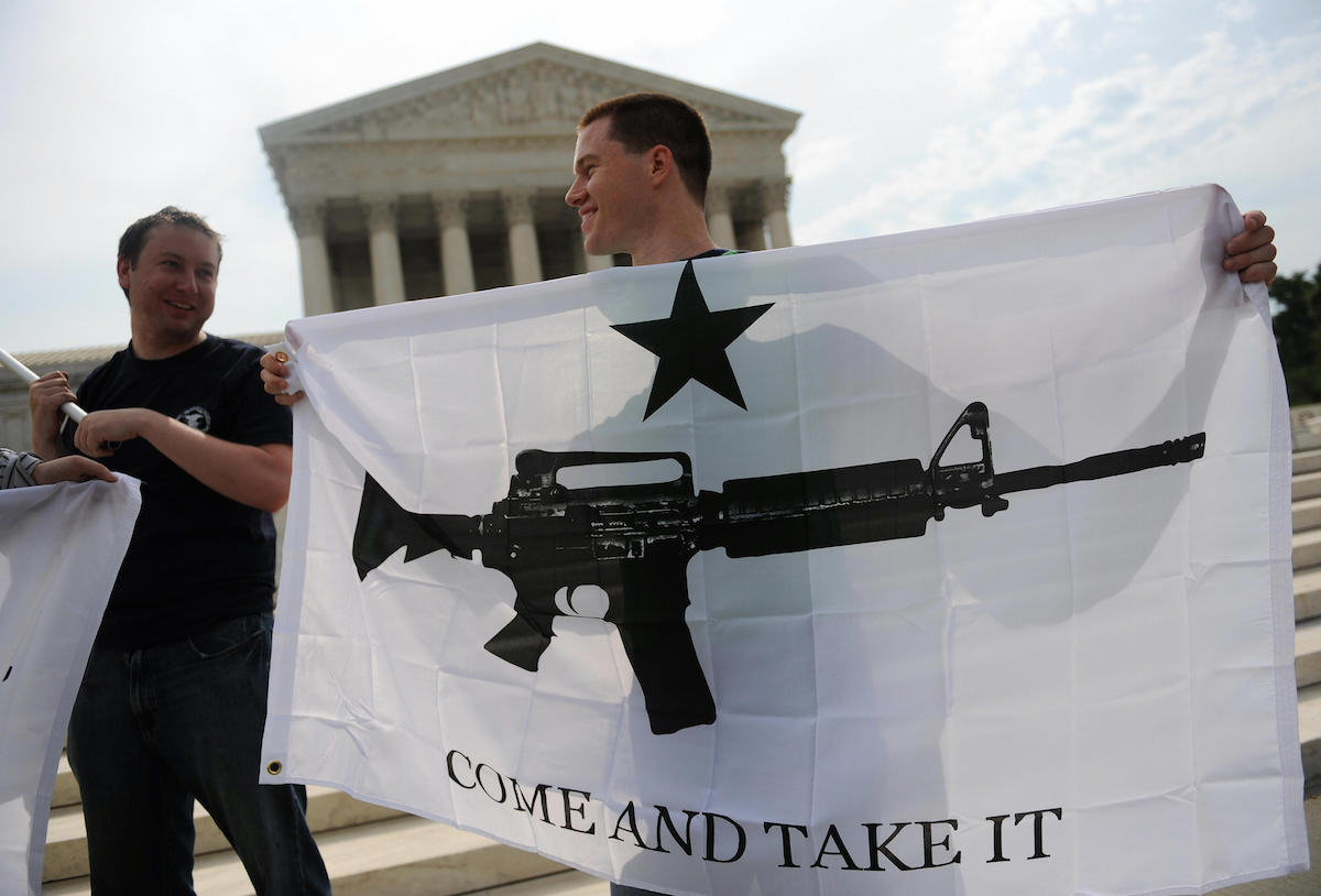 Gun rights activists celebrate the news from the U.S. Supreme Court on June 26, 2008 that ended a ban on owning handguns in Washington, D.C. (Tim Sloan—AFP/Getty Images)