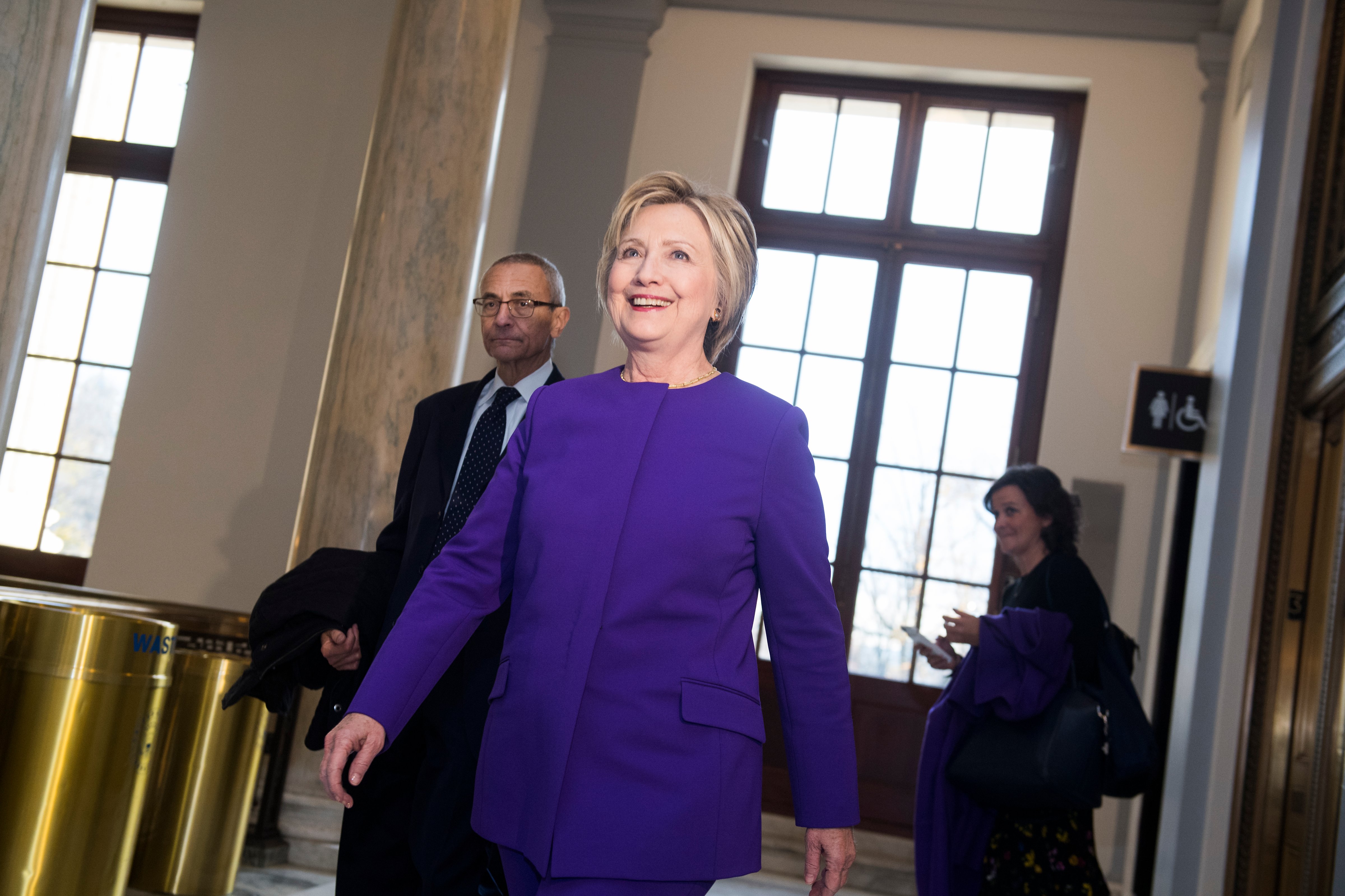 Former Secretary of State Hillary Clinton and John Podesta arrive for a portrait unveiling ceremony for retiring Senate Minority Leader Harry Reid, D-Nev., in Russell Building's Kennedy Caucus Room, December 08, 2016. (Tom Williams&mdash;CQ-Roll Call,Inc.)