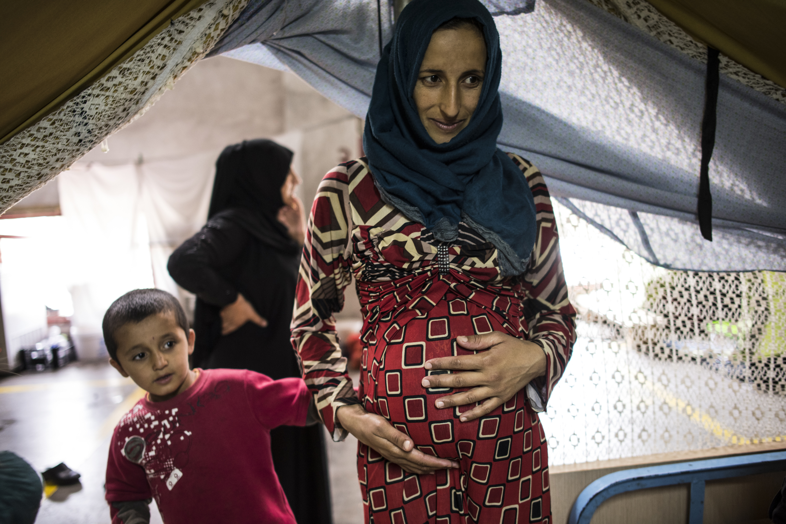 Illham Alarabi and her son in their  tent at the Oreokastro camp outside of Thessaloniki, Greece, September 9, 2016.  Over nine million Syrians have been displaced from their homes due to years of civil war in the country.