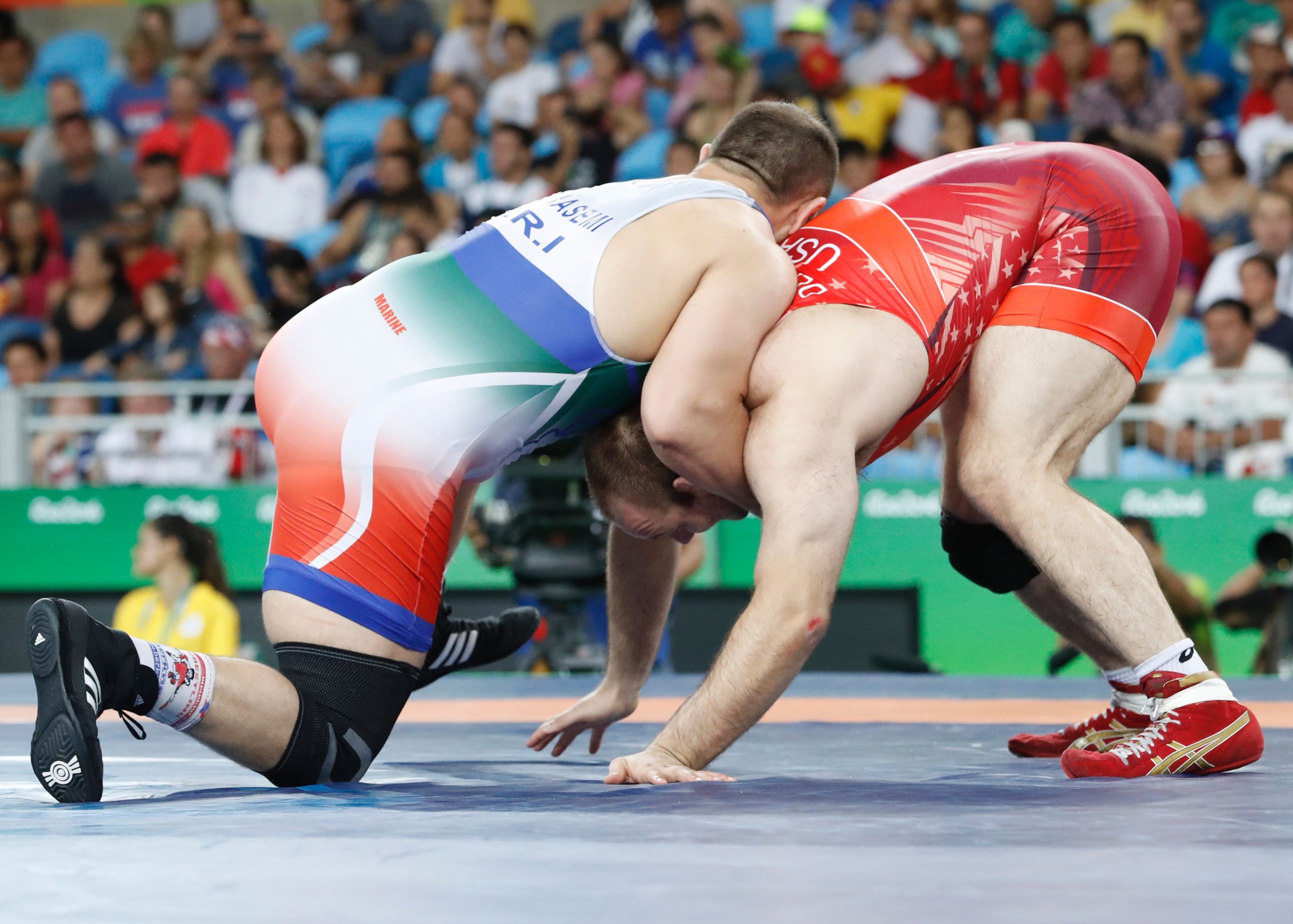 Iran's Komeil Nemat Ghasemi (blue) wrestles with USA's Tervel Ivaylov Dlagnev in their men's 125kg freestyle semi-final match on August 20, 2016, during the wrestling event of the Rio 2016 Olympic Games at the Carioca Arena 2 in Rio de Janeiro. / AFP / Jack GUEZ (Photo credit should read JACK GUEZ/AFP/Getty Images)
