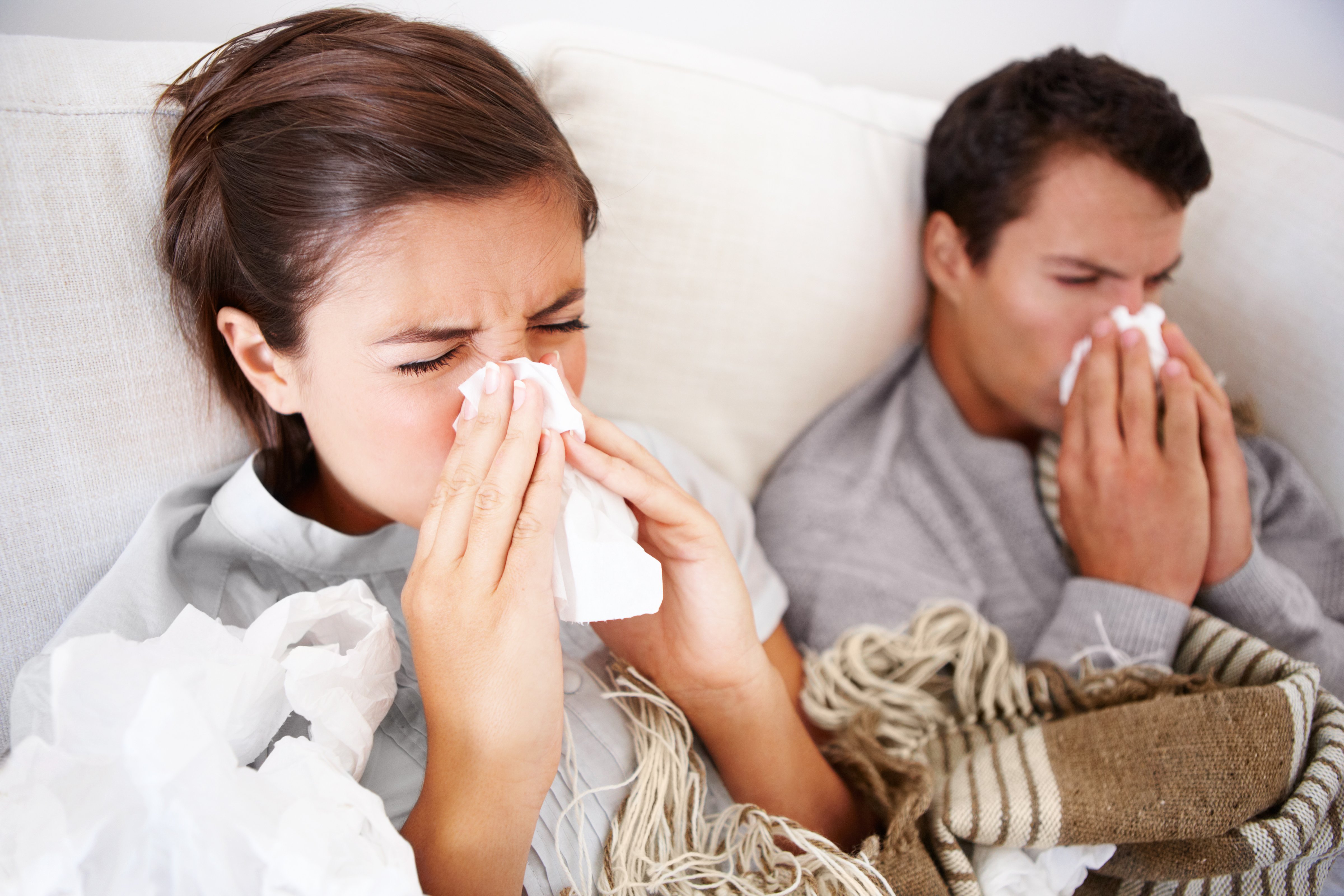 Young couple fighting the flu as they both lay in bed (Getty Images)