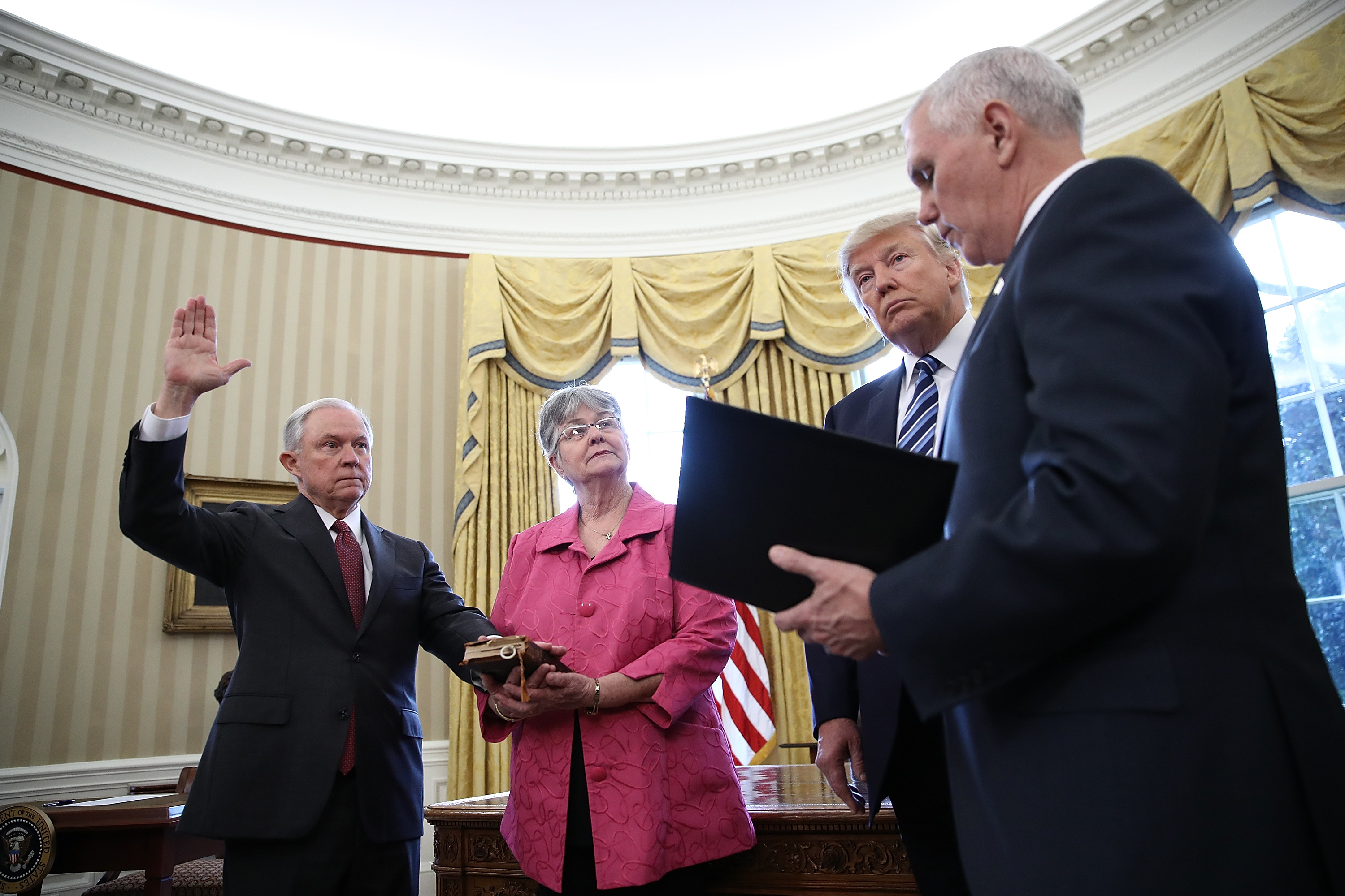 U.S. President Donald Trump (2nd R) watches as Jeff Sessions (L) is sworn in as the new U.S. Attorney General by U.S. Vice President Mike Pence (R) in the Oval Office of the White House on Feb. 9, 2017, in Washington, D.C. (Win McNamee&mdash;Getty Images)