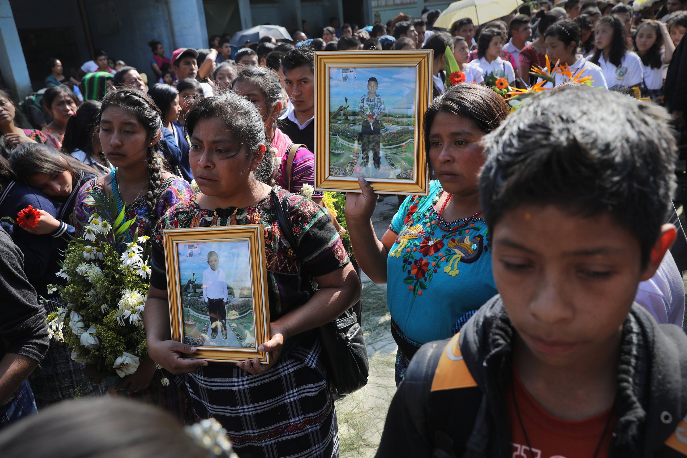 Mothers carry portraits of their sons who were kidnapped and killed in San Juan Sacatepéquez, Guatemala on Feb. 14, 2017.