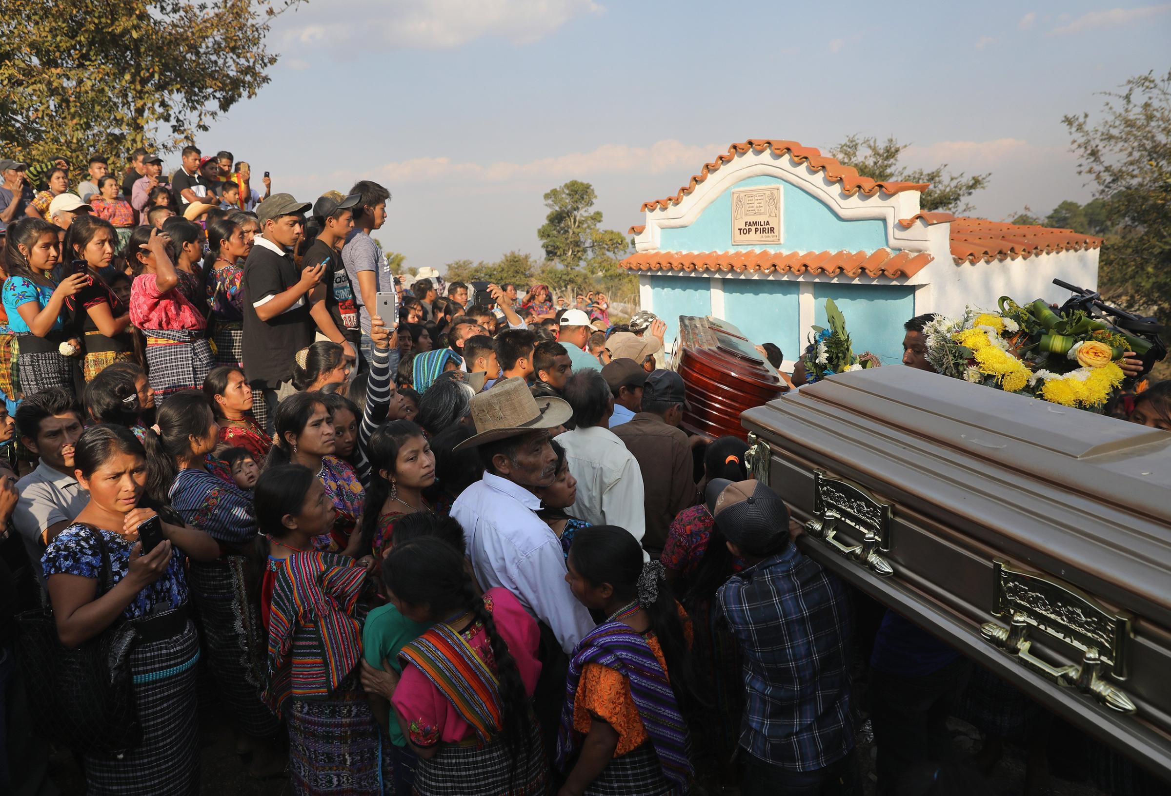 The bodies of two boys who were kidnapped and killed arrive to a cemetery for burial in San Juan Sacatepéquez, Guatemala, on Feb. 14, 2017.