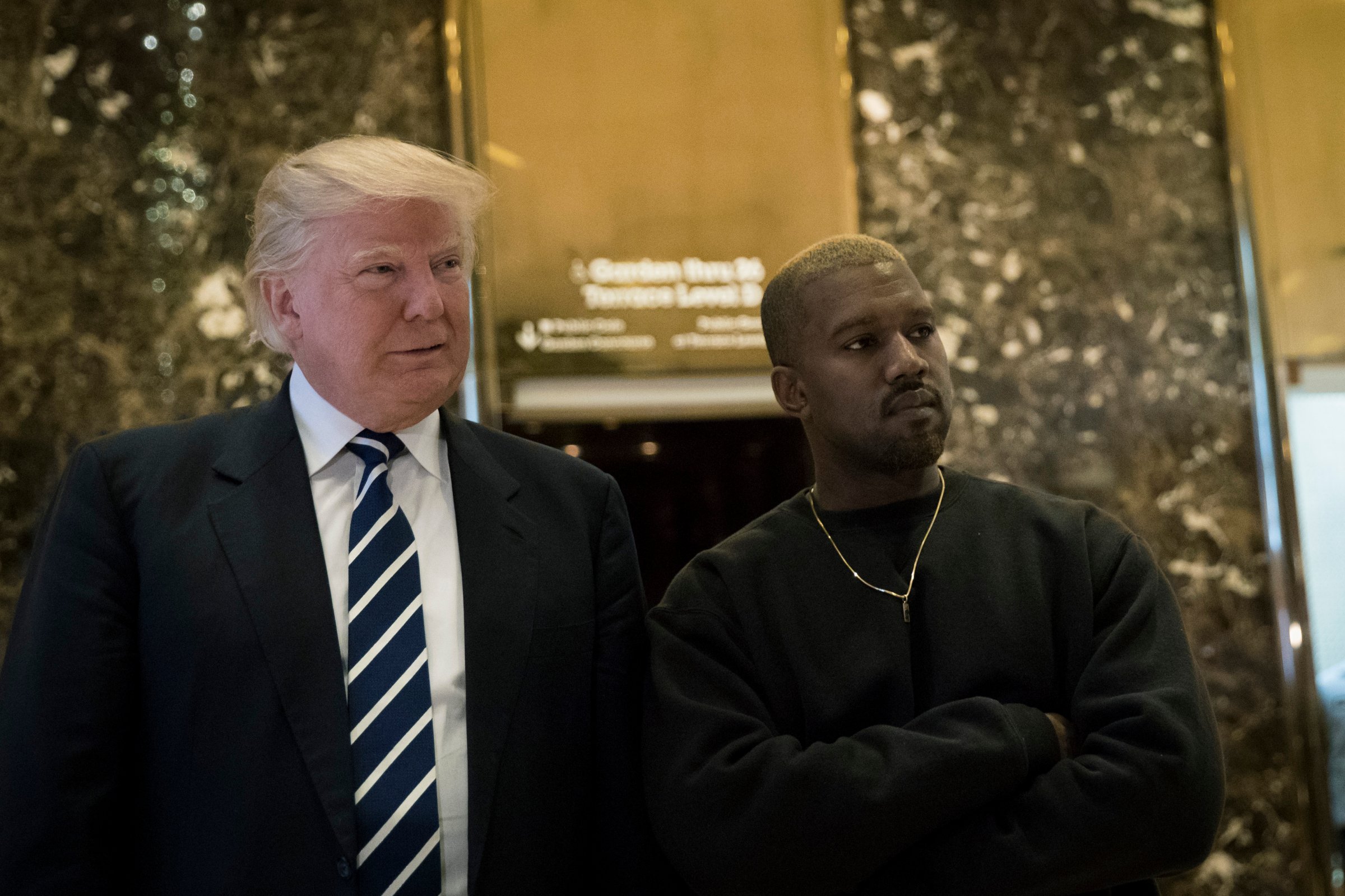 (L to R) President-elect Donald Trump and Kanye West stand together in the lobby at Trump Tower, December 13, 2016 in New York City.