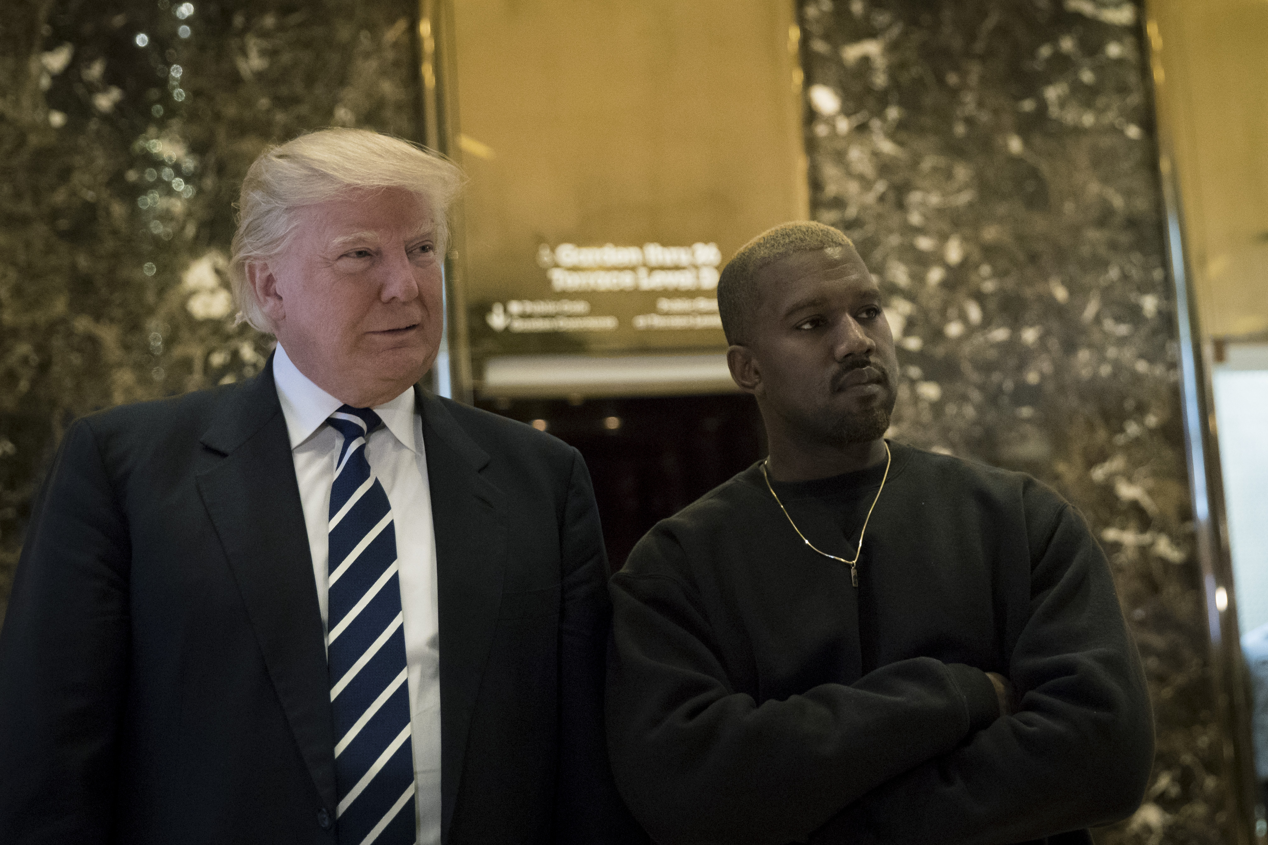 (L to R) President-elect Donald Trump and Kanye West stand together in the lobby at Trump Tower, December 13, 2016 in New York City. (Drew Angerer/Getty Images)