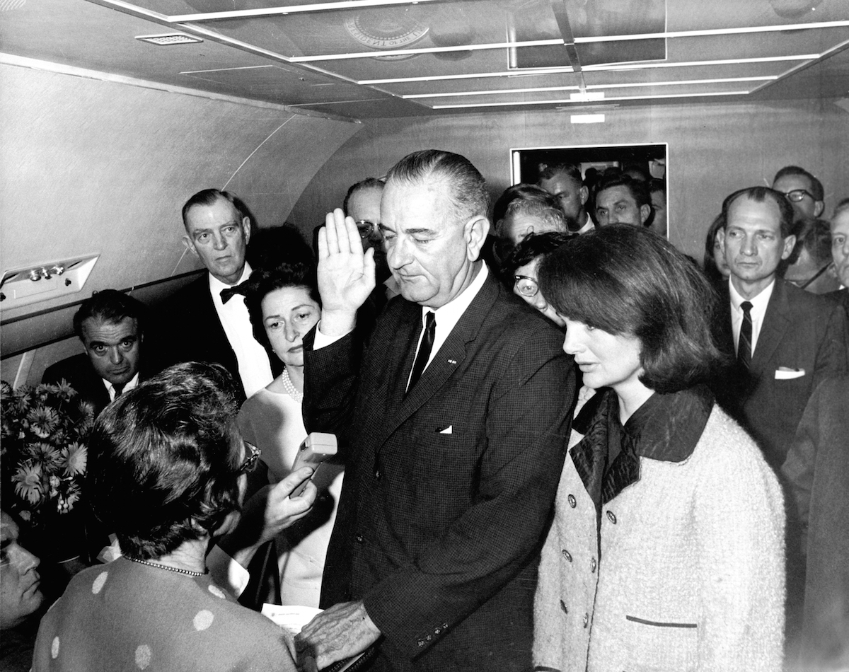In the aftermath of the assasination of U.S. President John F. Kennedy, Lyndon Baines Johnson takes the oath of office to become the 36th President of the United States, on  Air Force One, Dallas, Nov. 22, 1963. (Universal Images Group / Getty Images)