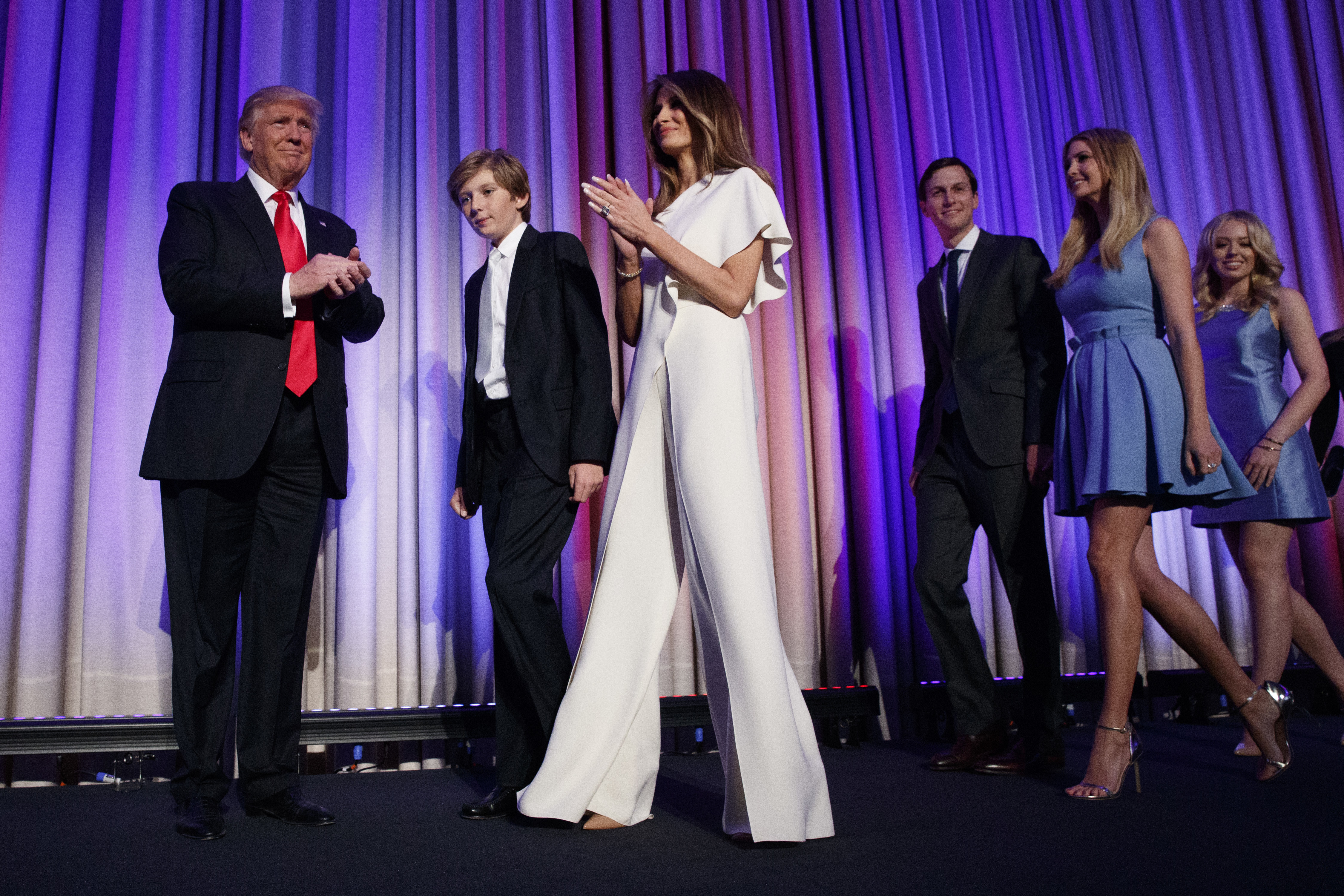 FILE - This Nov. 9, 2016 file photo shows Republican presidential candidate Donald Trump, left, arriving to speak to an election night rally in New York with his son Barron, from second left, wife Melania, son-in-law Jared Kushner and daughters Ivanka Trump and Tiffany Trump. Throughout the bruising presidential race, Mrs. Trump kept her look to typical wealthy socialite. Her blouses were often jewel toned, her dresses and jumpsuits from European designers that include Gucci and Roland Mouret, but Americans, too. (AP Photo/ Evan Vucci, File)