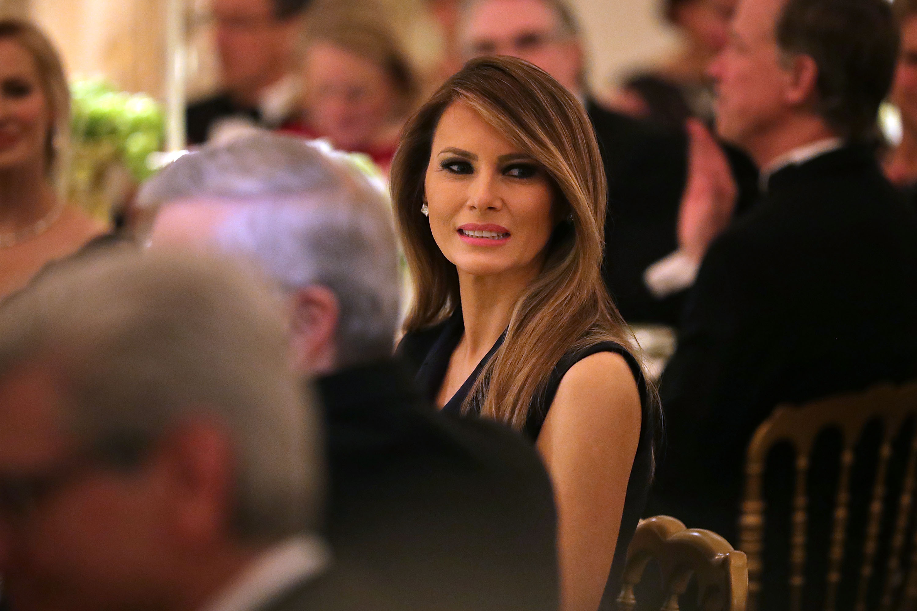 U.S. first lady Melania Trump listens to a toast by her husband President Donald Trump while hosting the annual Governors' Dinner in the East Room of the White House February 26, 2017 in Washington, DC. (Chip Somodevilla—;Getty Images)