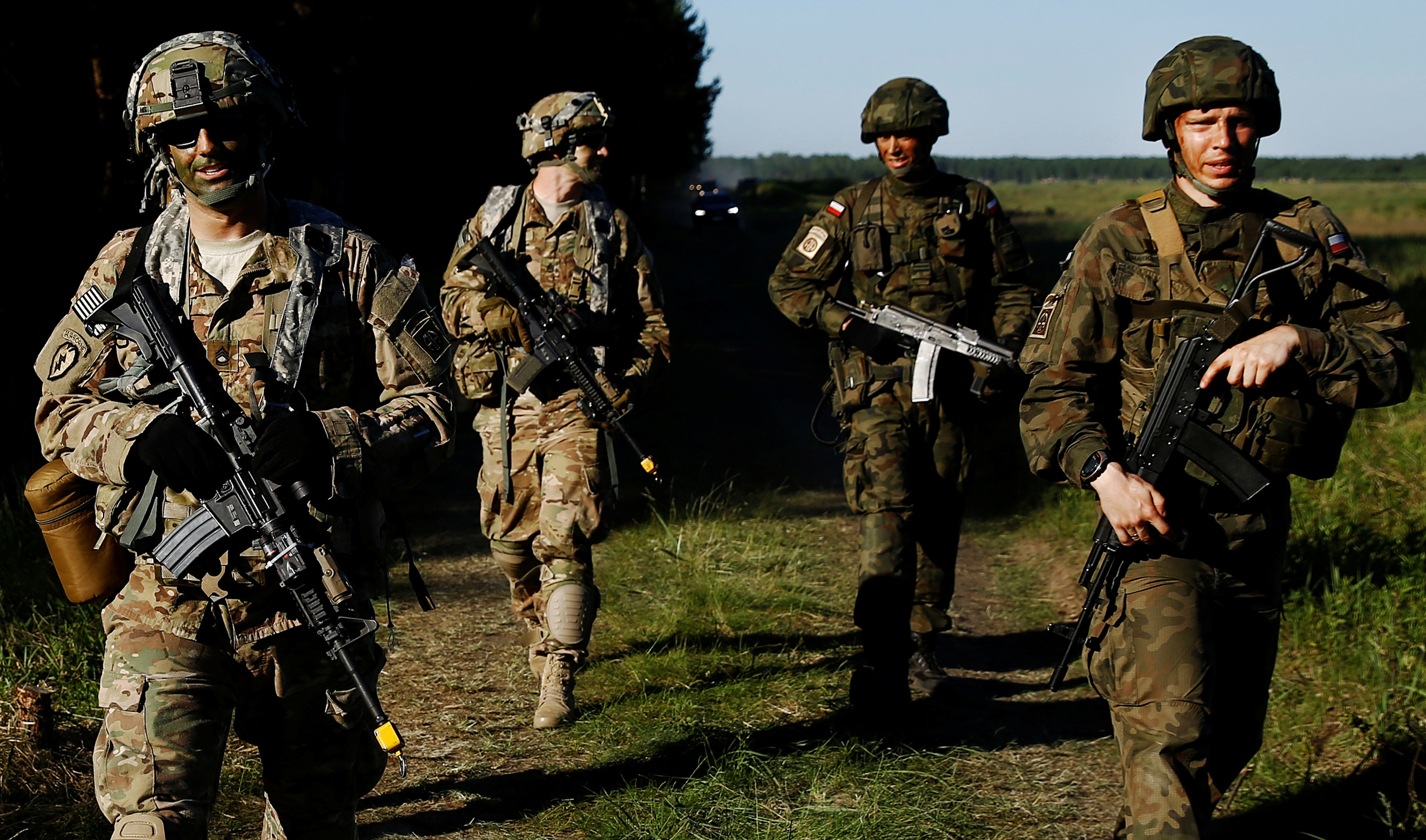 Poland's 6th Airborne Brigade soldiers walk with U.S. 82nd Airborne Division soldiers during the NATO allies' Anakonda 16 exercise near Torun