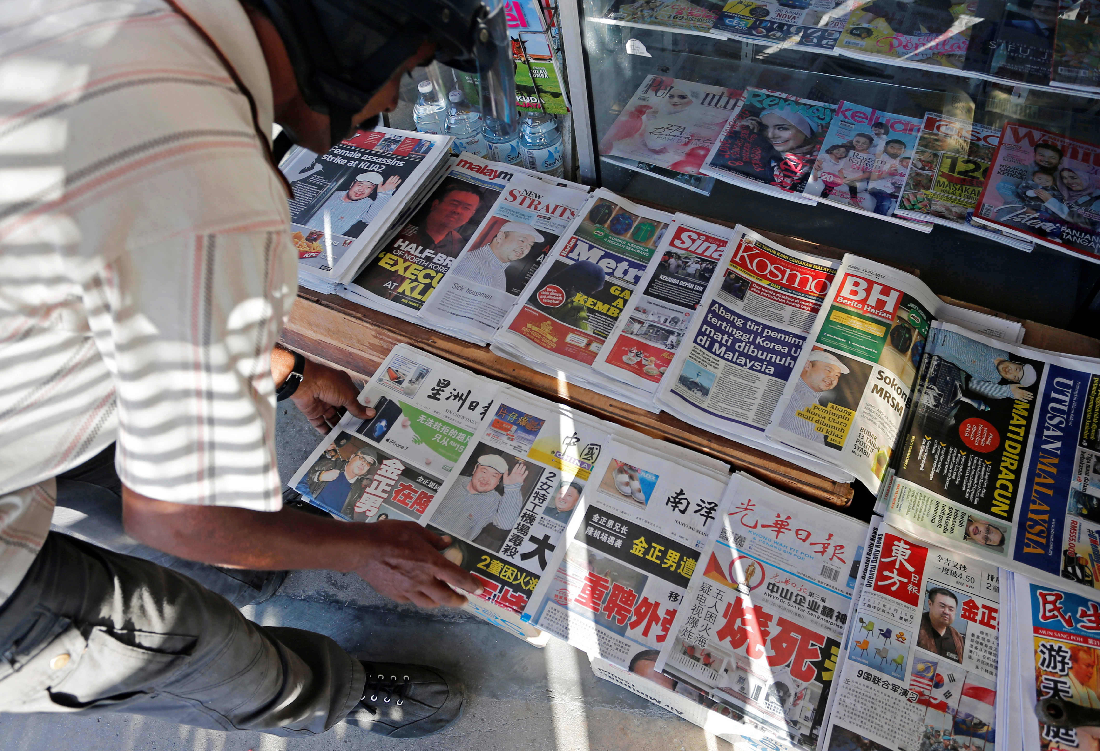 A newspaper vendor arranges newspapers showing front pages reporting the death of Kim Jong Nam, at a newsstand outside Kuala Lumpur on Feb. 15, 2017 (Lai Seng Sin—Reuters)