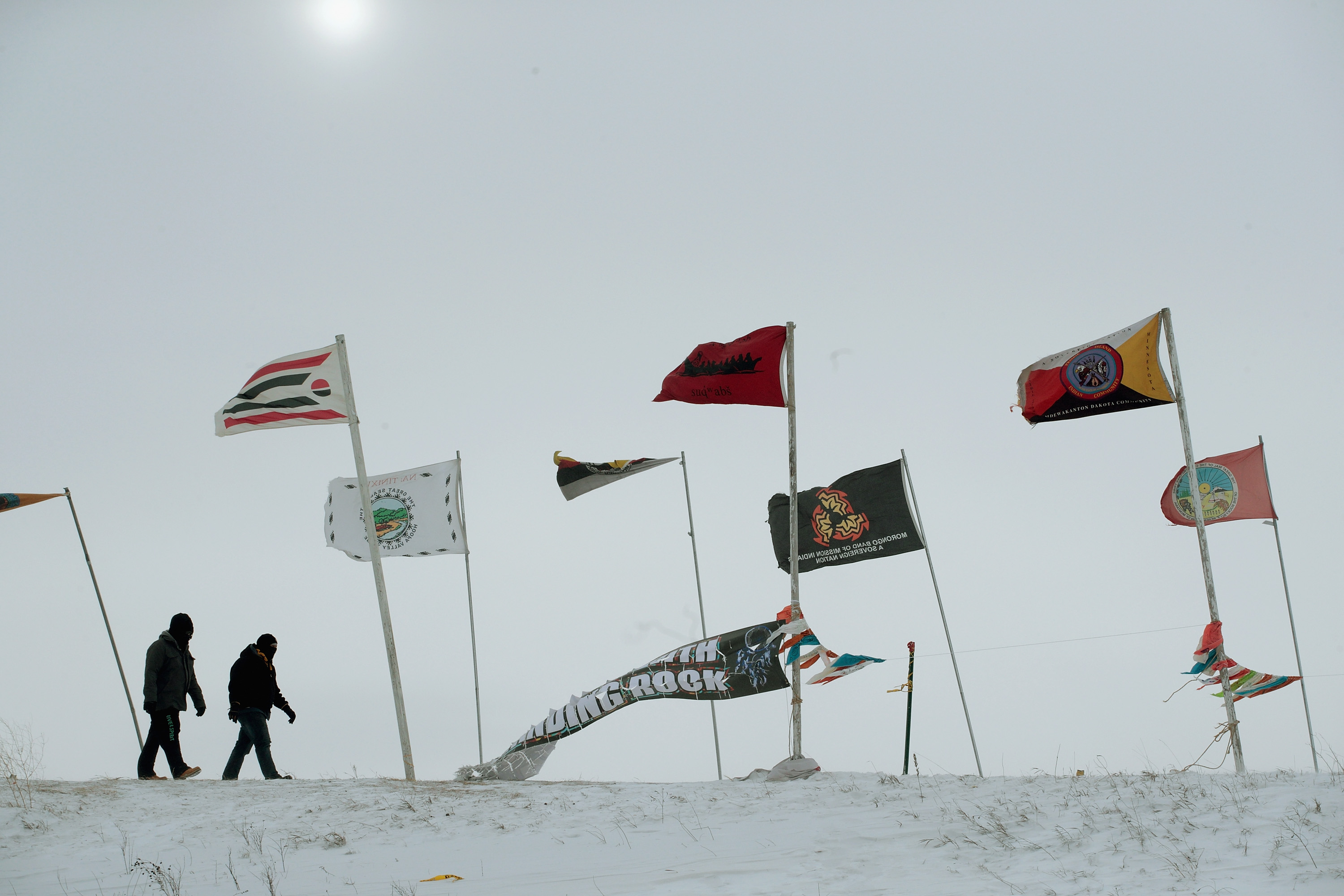 Activists fight the wind as they walk along Flag Road in Oceti Sakowin Camp as blizzard conditions grip the area around the Standing Rock Sioux Reservation on Dec. 6, 2016 outside Cannon Ball, North Dakota. (Scott Olson—Getty Images)