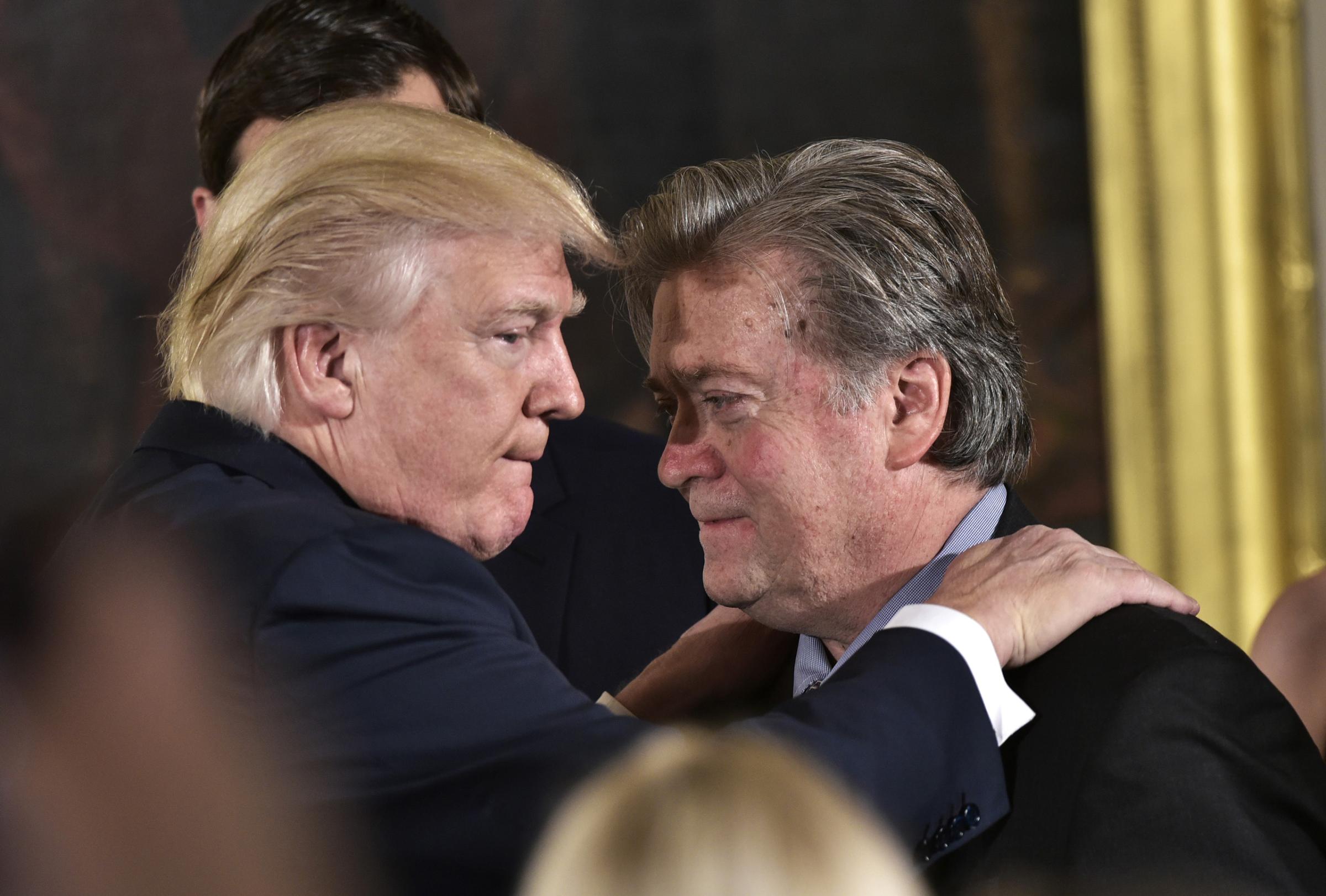 President Trump congratulates Bannon during the swearing-in of senior staff in the East Room of the White House, Jan. 22, 2017.