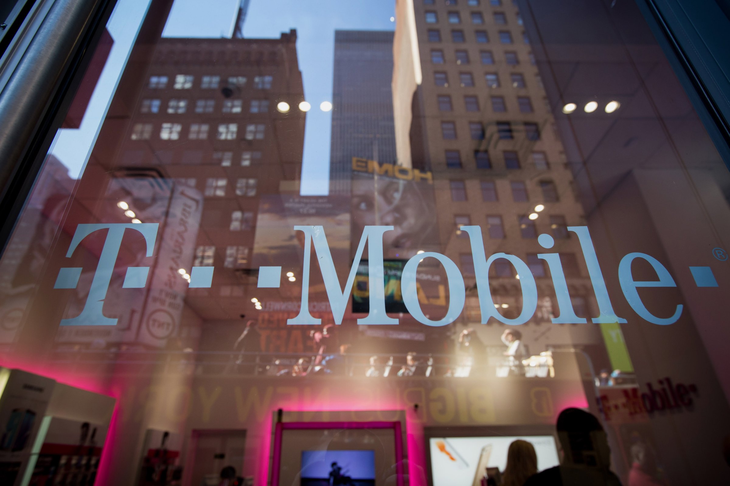 The T-Mobile US Inc. logo is displayed on a door at a T-Mobile US Inc. store in New York, U.S., on Monday, Oct. 26, 2015. T-Mobile US Inc. is scheduled to release earnings figures on October 27. Photographer: Michael Nagle/Bloomberg via Getty Images