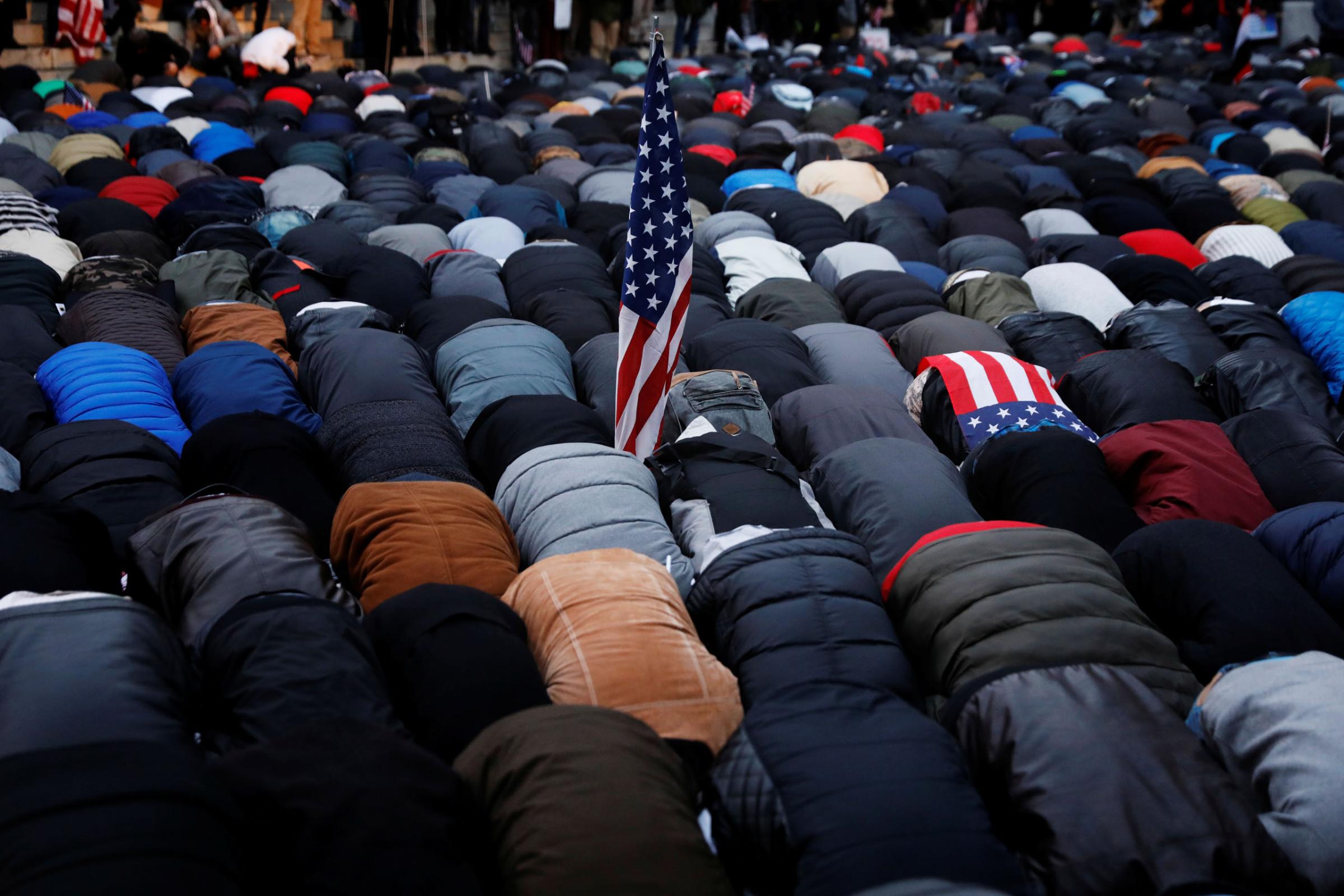 Demonstrators pray as they participate in a protest by the Yemeni community against U.S. President Donald Trump's travel ban in the Brooklyn borough of New York