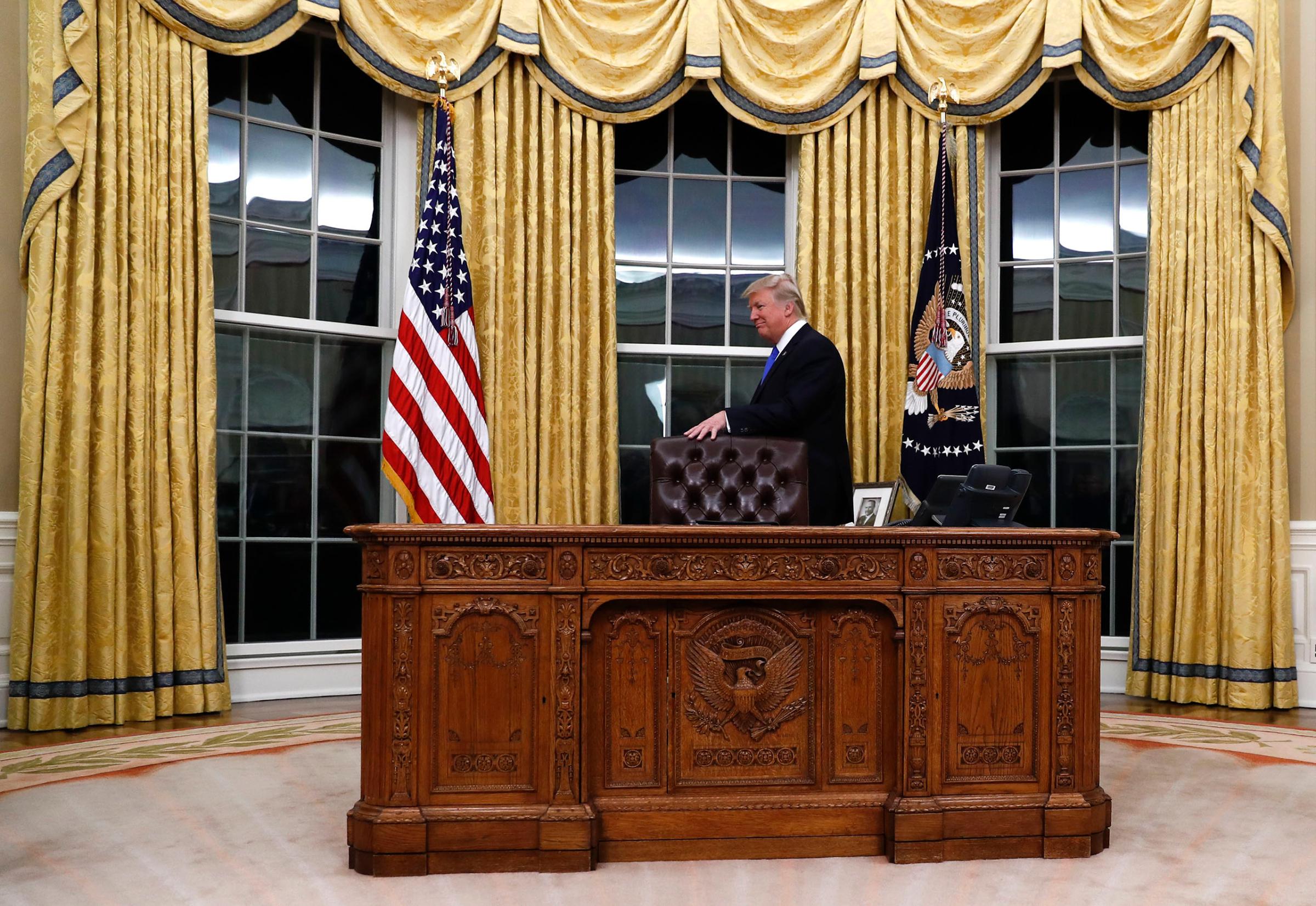 President Donald Trump walks around the Resolute desk during a ceremony for the swearing in of Rex Tillerson as Secretary of State in Oval Office of the White House in Washington, on Feb. 1, 2017.