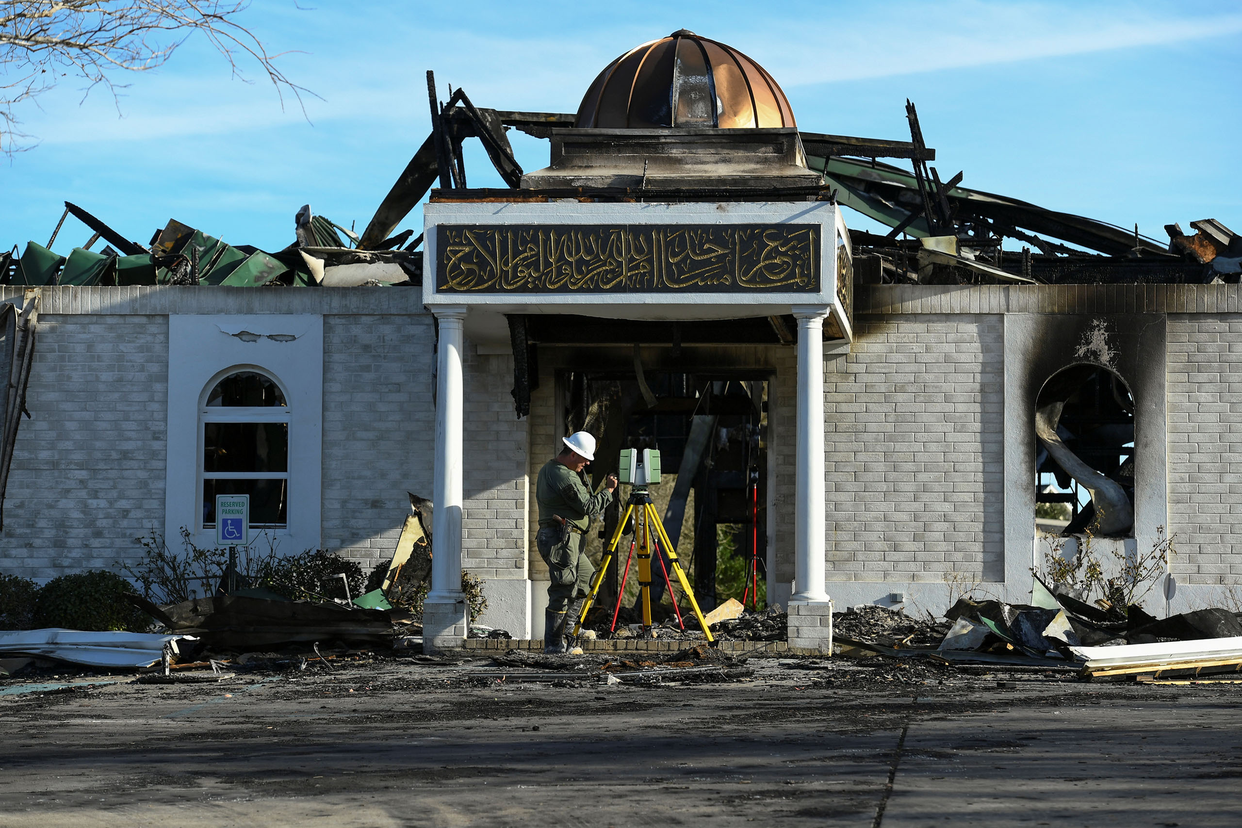 A security official investigates the aftermath of a fire at the Victoria Islamic Center mosque in Victoria, Texas