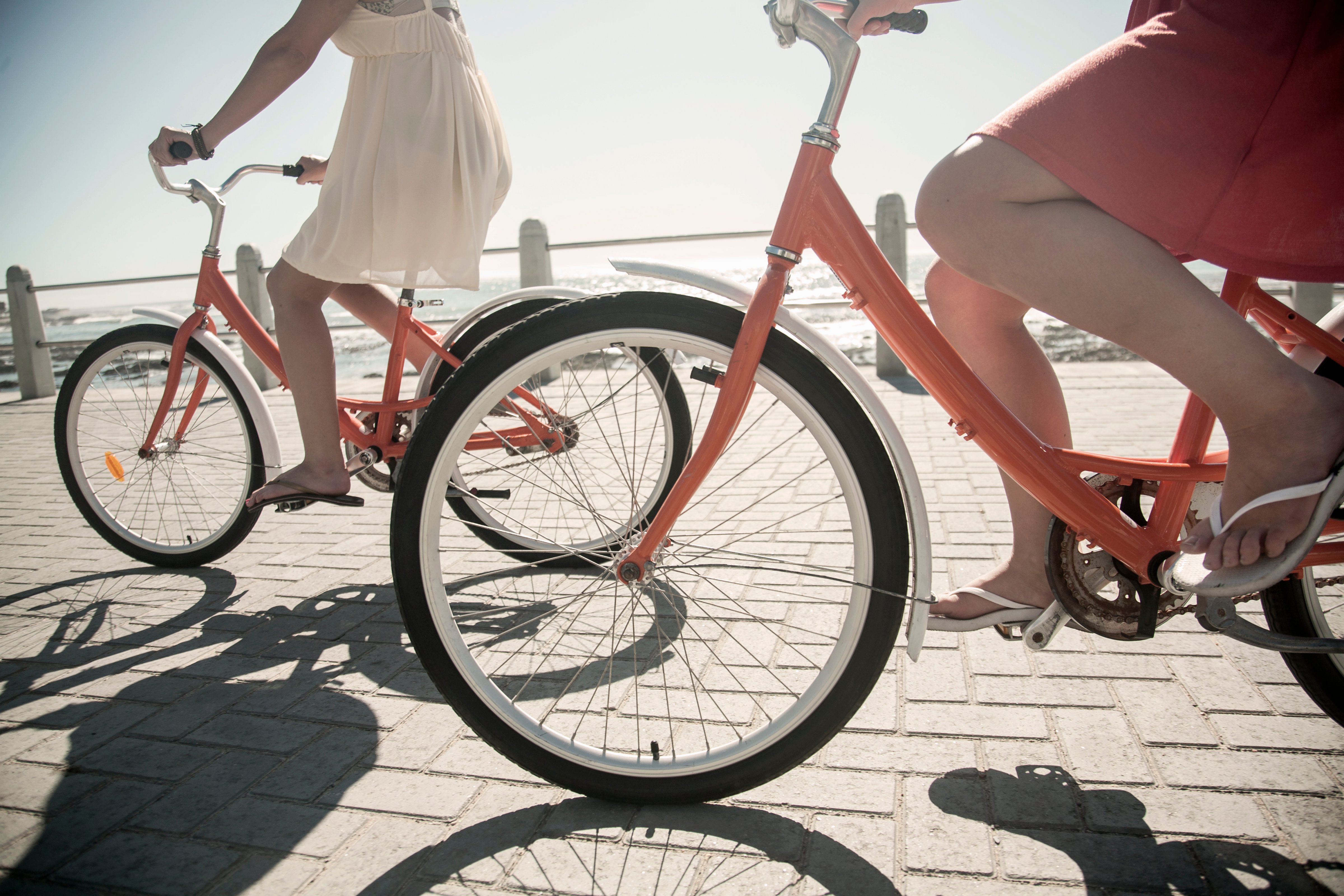 Young women cycling on seafront, Cape Town, South Africa (Getty Images)