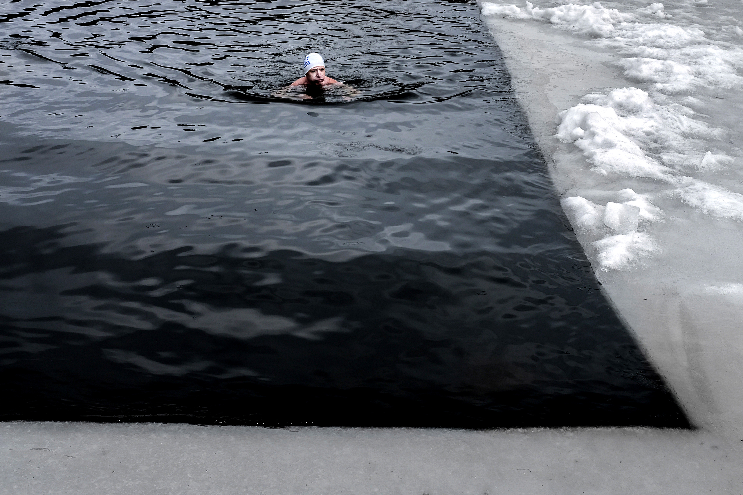A cold water swimmer has a quick splash around before an official competition begins in Sázava, in the Czech Republic, on Feb. 18 2017.