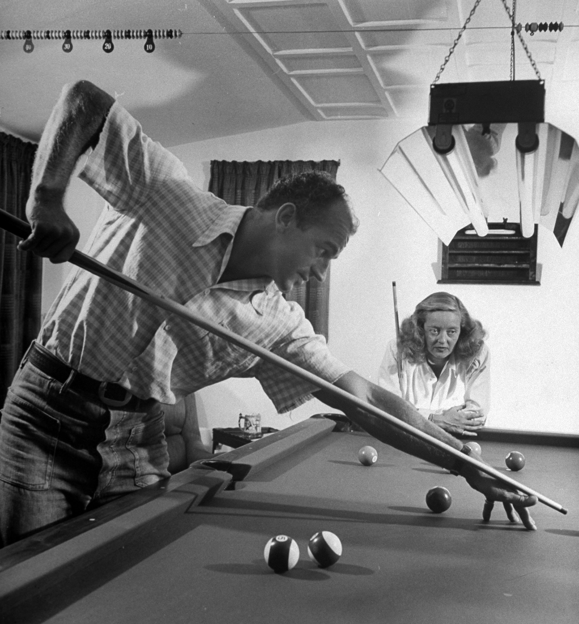 Bette Davis and her third husband, William Grant Sherry, playing billiards at home in California, 1947.