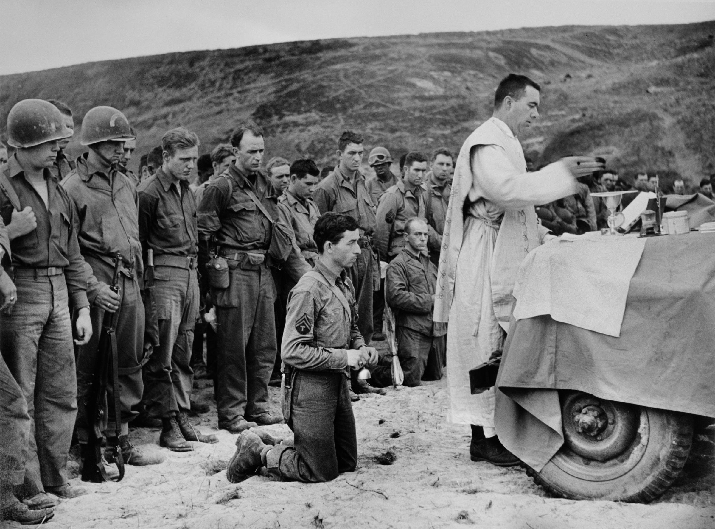 FRANCE. Normandy. June, 1944. A Catholic Priest conducts mass on Omaha Beach.