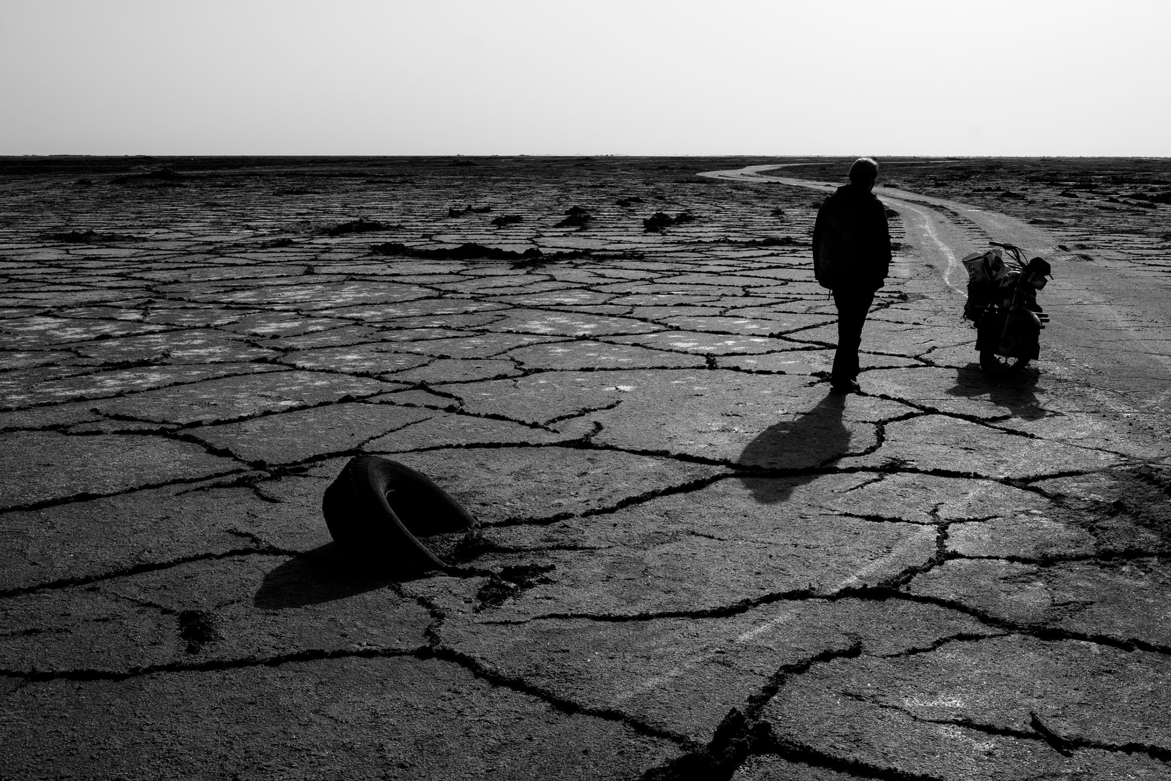 Cracked land of the Gavkhouni salt marsh, the terminal basin of the Zayandeh River in Isfahan Province, Iran. Droughts and water mismanagement have contributed to Iran's water crisis, May 2016.